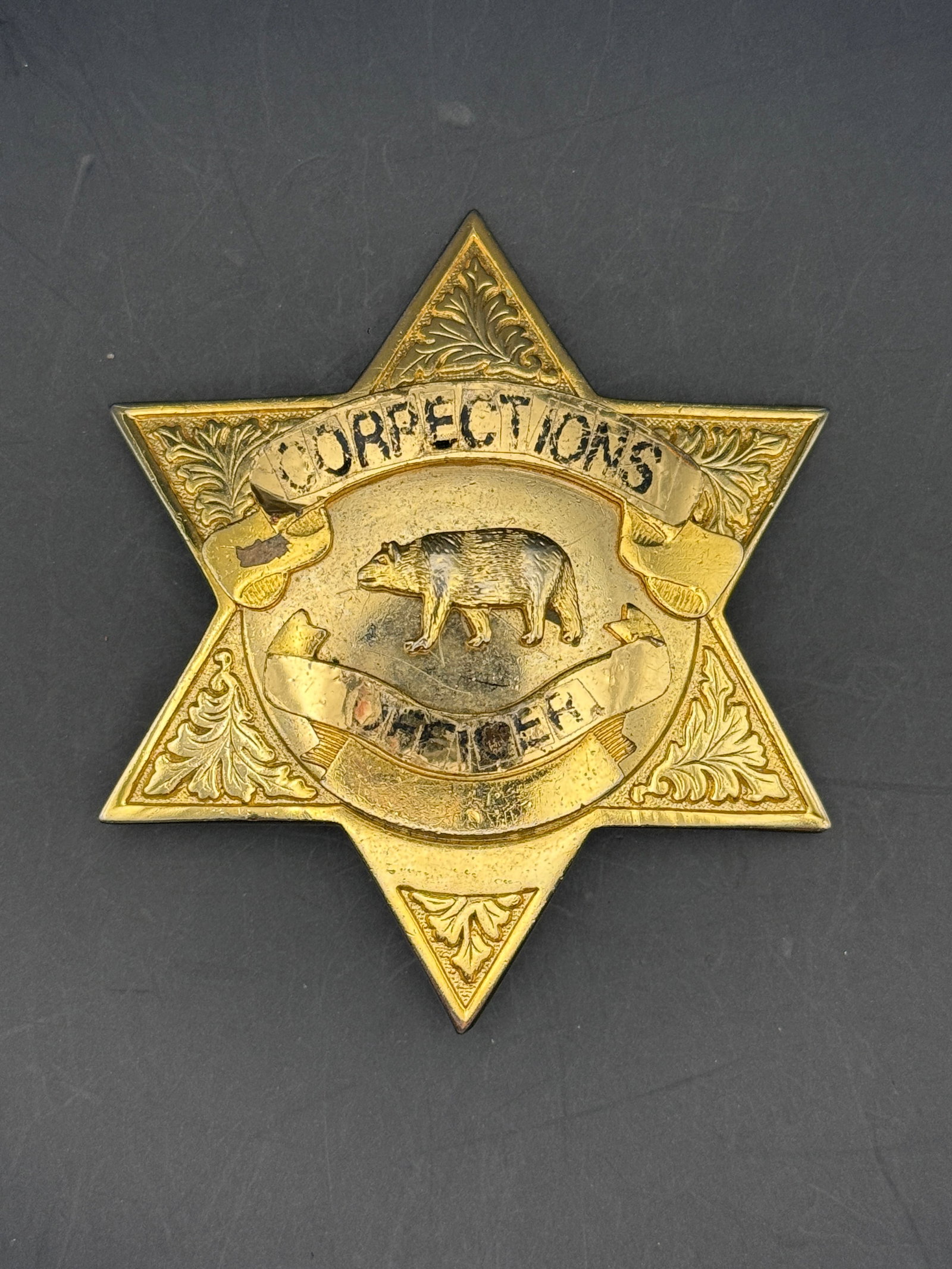 1940s San Bernardino County California Corrections Officer Badge: Vintage 1940s San Bernardino County, California corrections officer badge featuring a six-point star design with embossed foliate decoration, central California bear emblem, and banner scrollwork read