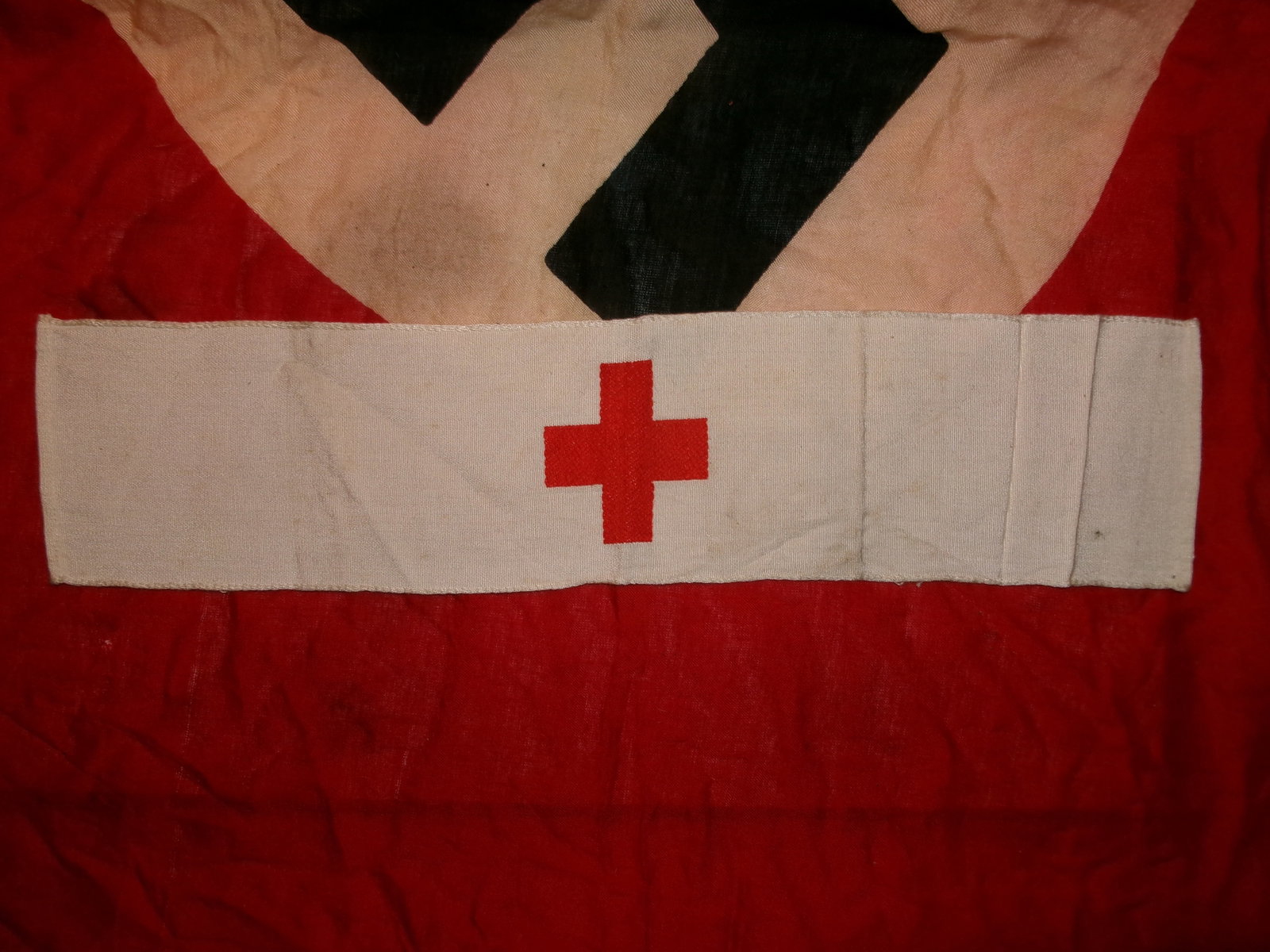 WWII German Red Cross Medical Armband: White cotton medical identification armband featuring a centrally applied red cross emblem. Armbands of this type were worn by German medical personnel, field medics, and auxiliary staff during the Se