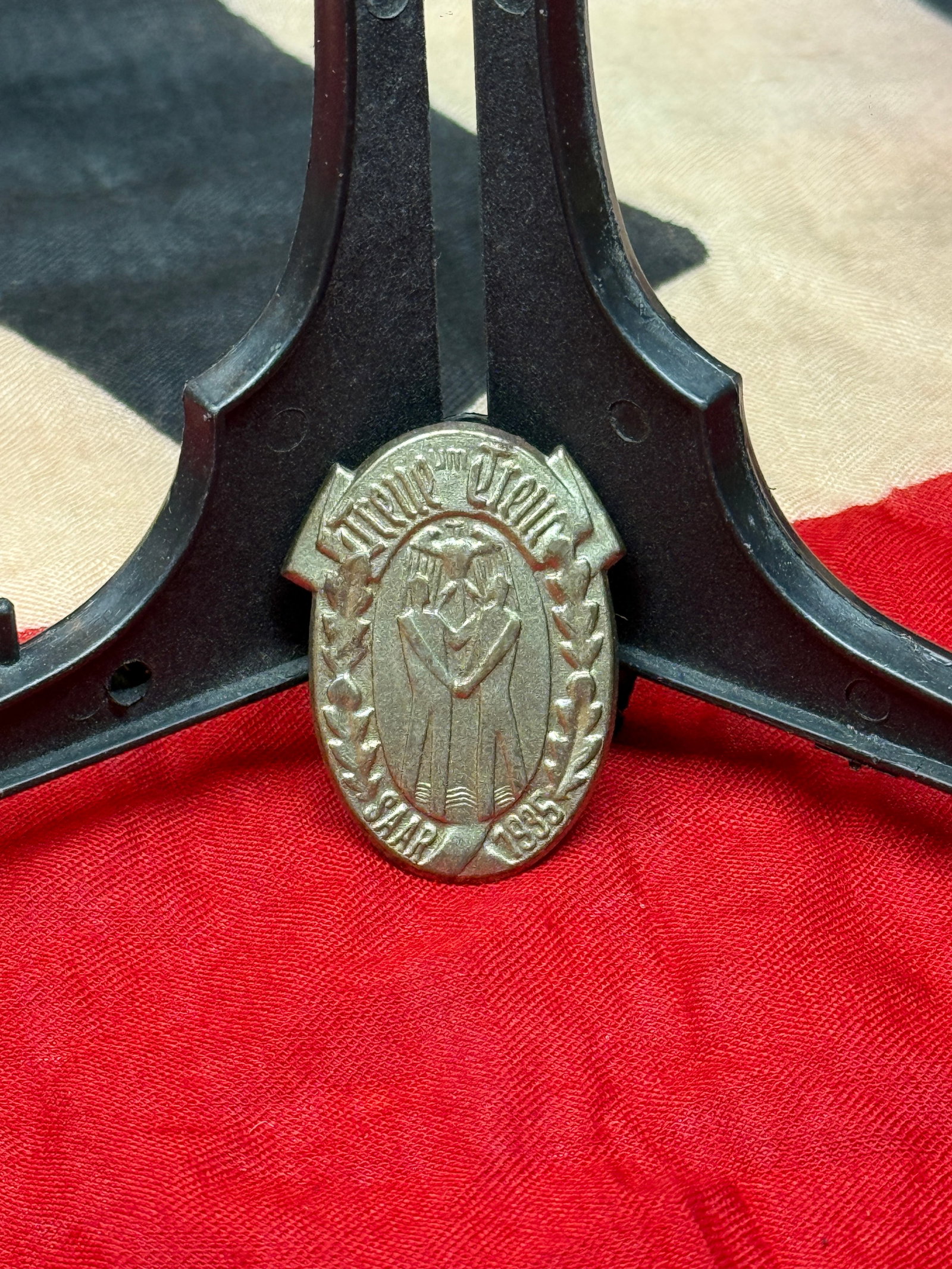 German “Treue um Treue?? Commemorative Badge, Dated 1935: Small oval German commemorative badge bearing the inscription “Treue um Treue” (“Loyalty for Loyalty”) above a stylized eagle motif and the date 1935. Constructed of a cast non-ferrous