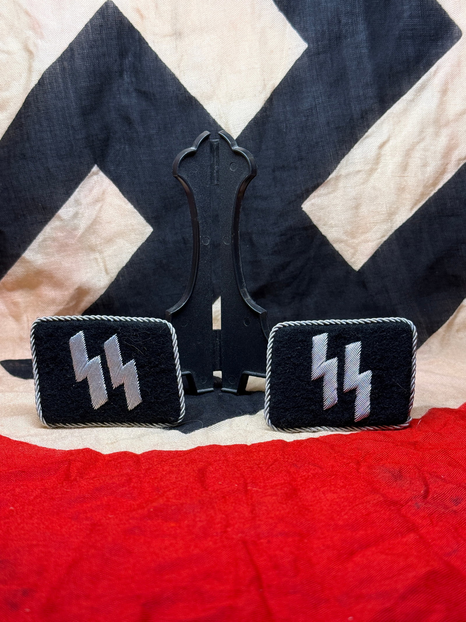 German Allgemeine-SS Officer’s Collar Tabs (WWII Era): These black wool collar tabs display the distinctive silver SS runes embroidered in metallic thread and bordered with twisted silver piping. Intended for wear on the collar of SS uniforms during the S