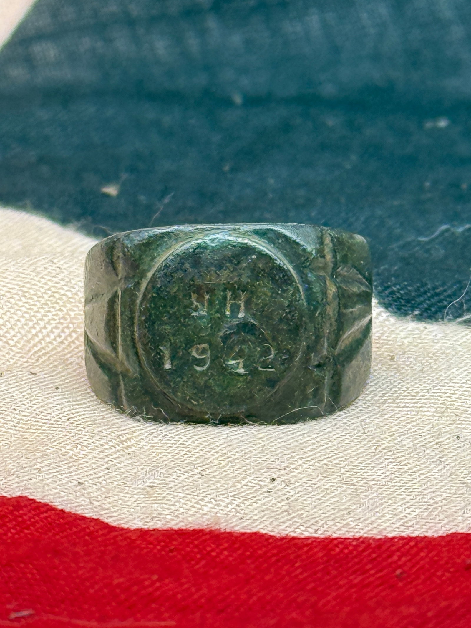 WWII German Commemorative Ring Dated 1942: This dark metal ring features a raised oval bezel engraved with the date “1942,” accompanied by stylized shoulder detailing that tapers into a plain band. Rings of this nature were commonly wo