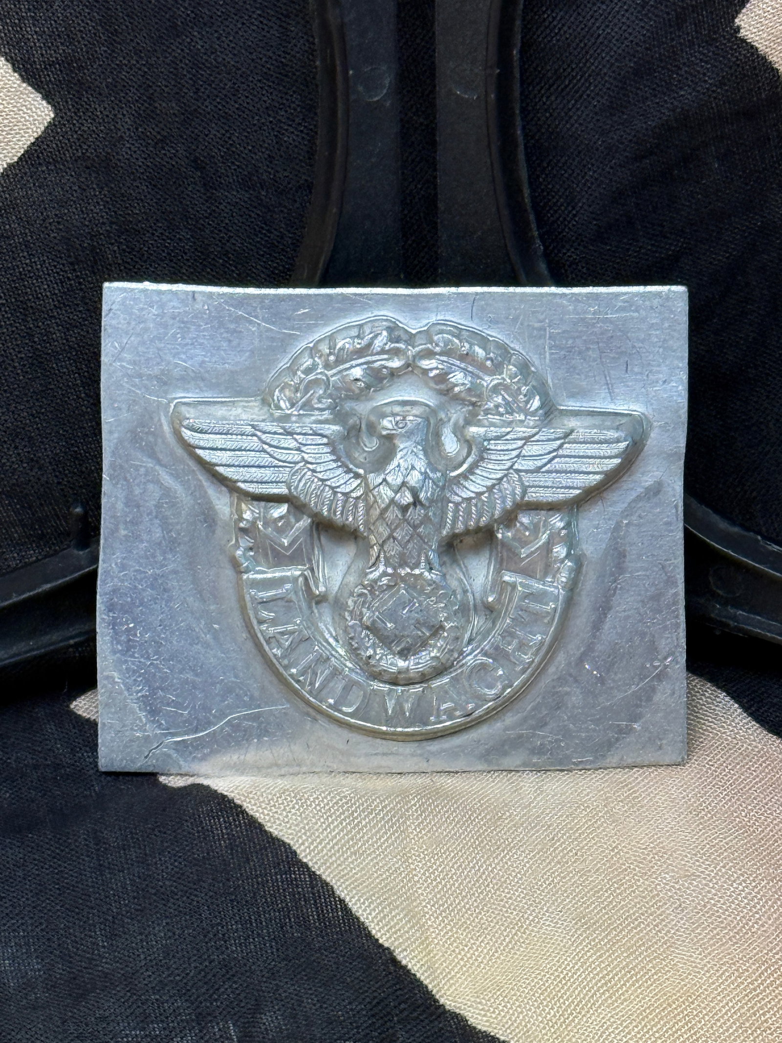 WWII German Political Eagle Metal Manufacturing Die: This engraved metal die features a German political eagle above a wreath enclosing a swastika, accompanied by the slogan “Deutschland Erwache” (“Germany Awake”). Produced as a manufact