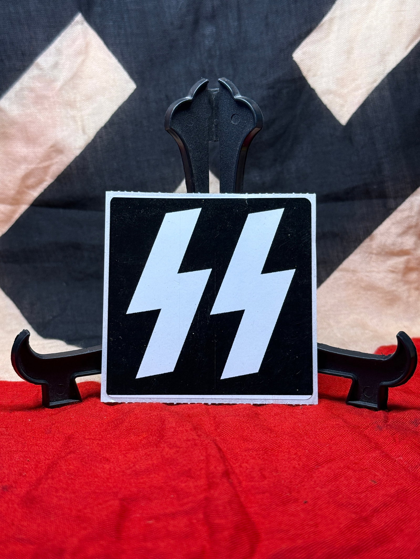 German Waffen-SS Double Rune Decal Sticker: This adhesive decal displays the double-rune insignia historically associated with the Waffen-SS, the military branch of the Schutzstaffel (SS) during World War II. The design consists of two white an