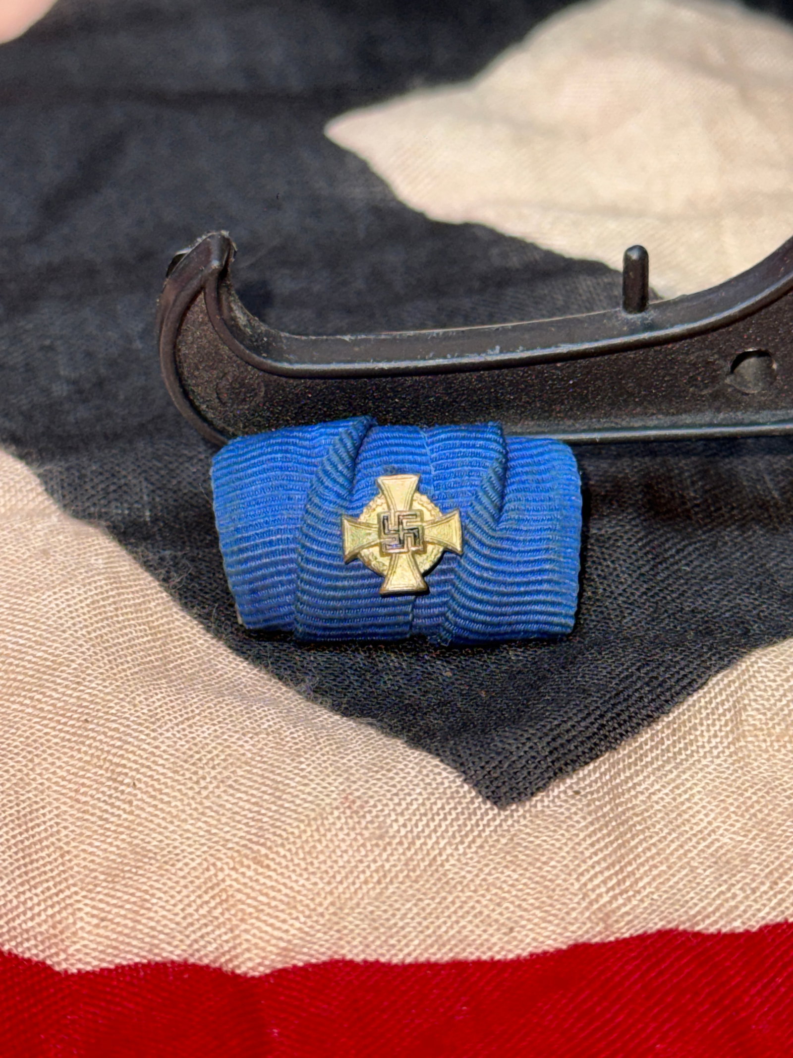 WWII German Mother's Cross Ribbon Bar (Ehrenkreuz der Deutschen Mutter): Blue ribbon bar fitted with a miniature Mother's Cross device, representing the Ehrenkreuz der Deutschen Mutter (Cross of Honour of the German Mother), an award instituted in 1938 to recognize women w