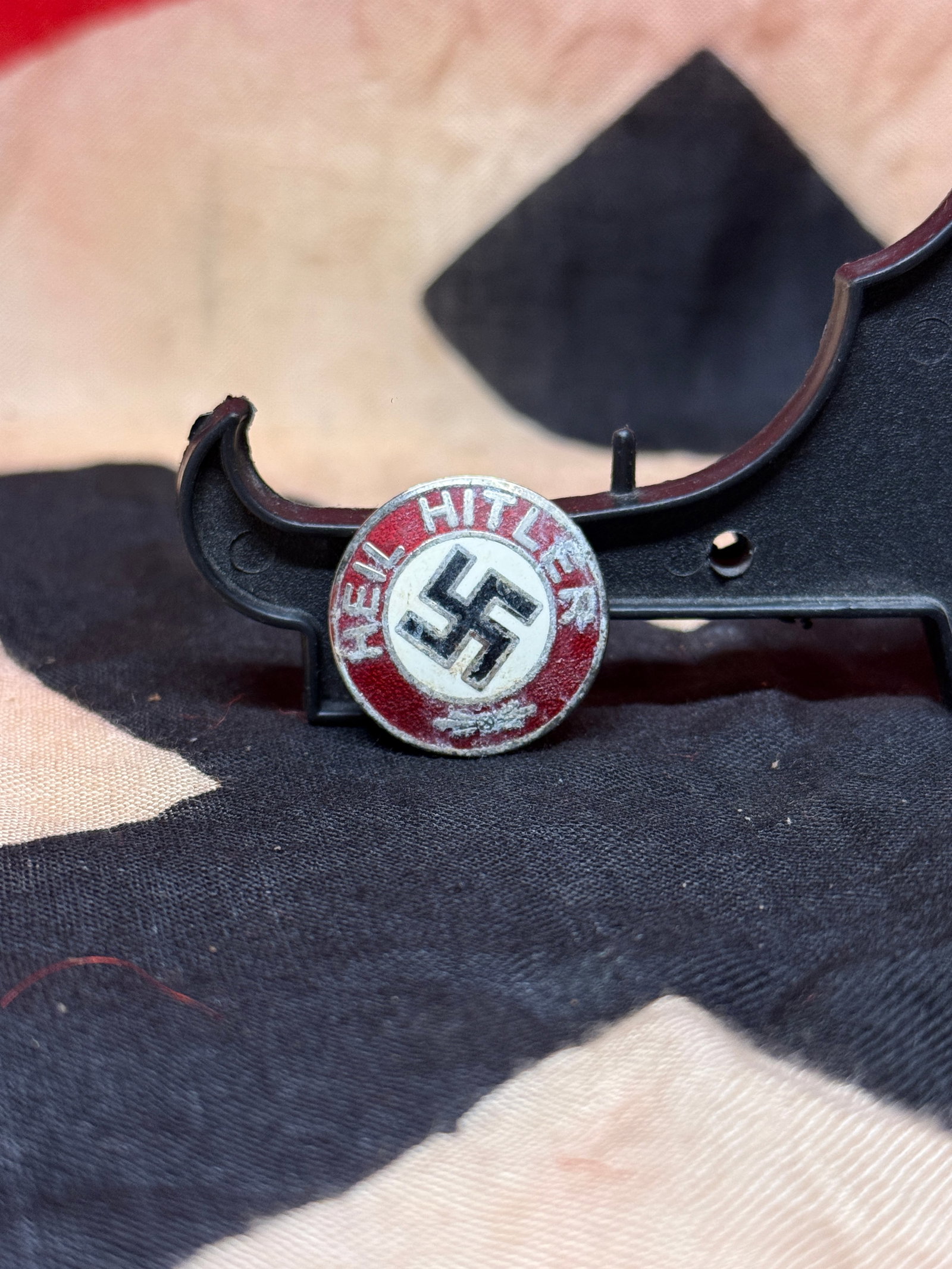 World War II German NSDAP Party Membership Badge (M1/29 Marked): Official NSDAP Party Membership Badge featuring a black swastika on a white enamel field surrounded by a red border bearing the inscription “Adolf Hitler.” The reverse retains its original pin