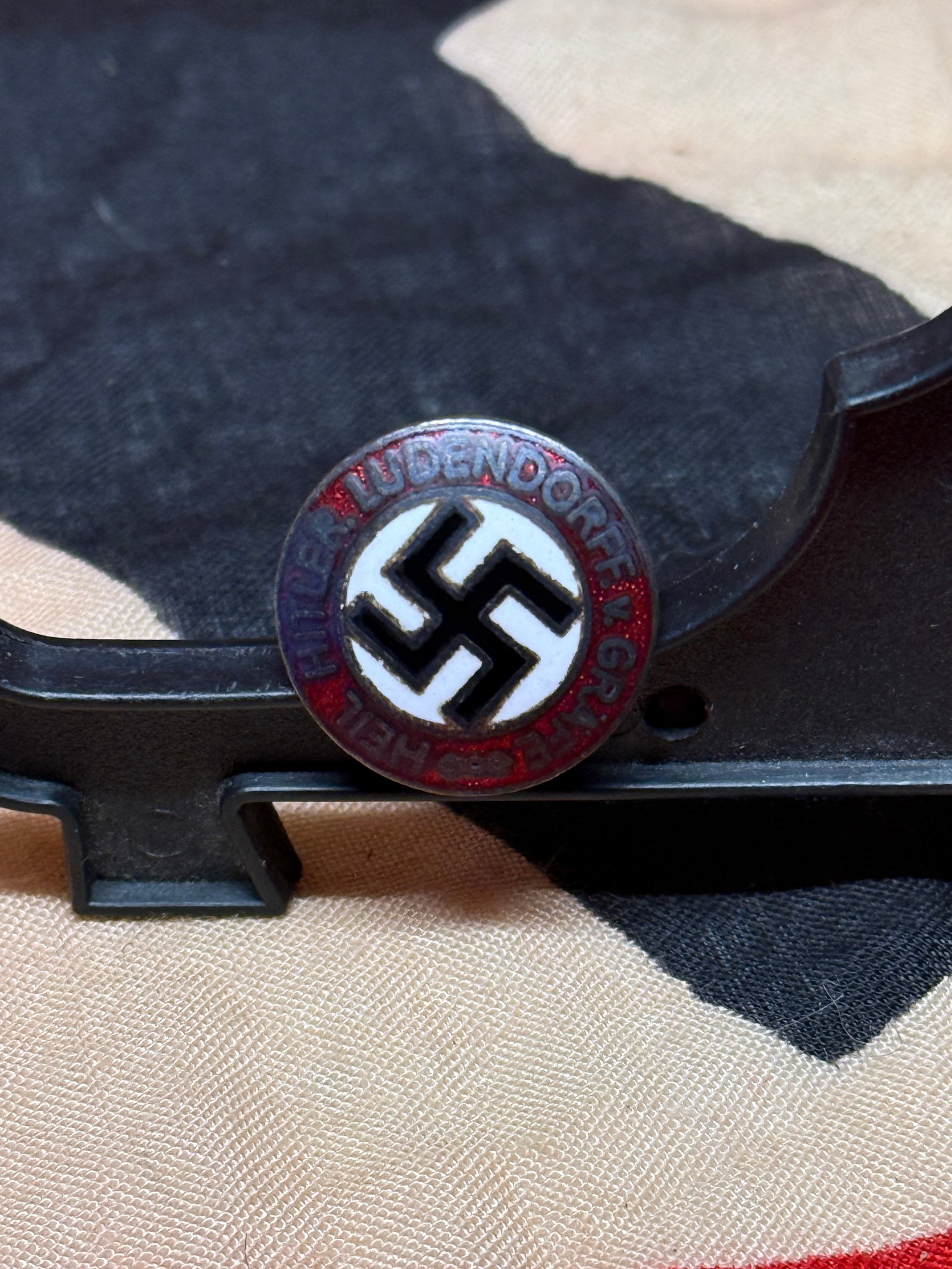 WWII German Hitler Youth Membership Badge (Hitlerjugend Abzeichen): Enamel membership badge of the Hitler Youth (Hitlerjugend) organization, featuring a black swastika within a white diamond set against a red field. The surrounding red ring bears the motto “Blut und