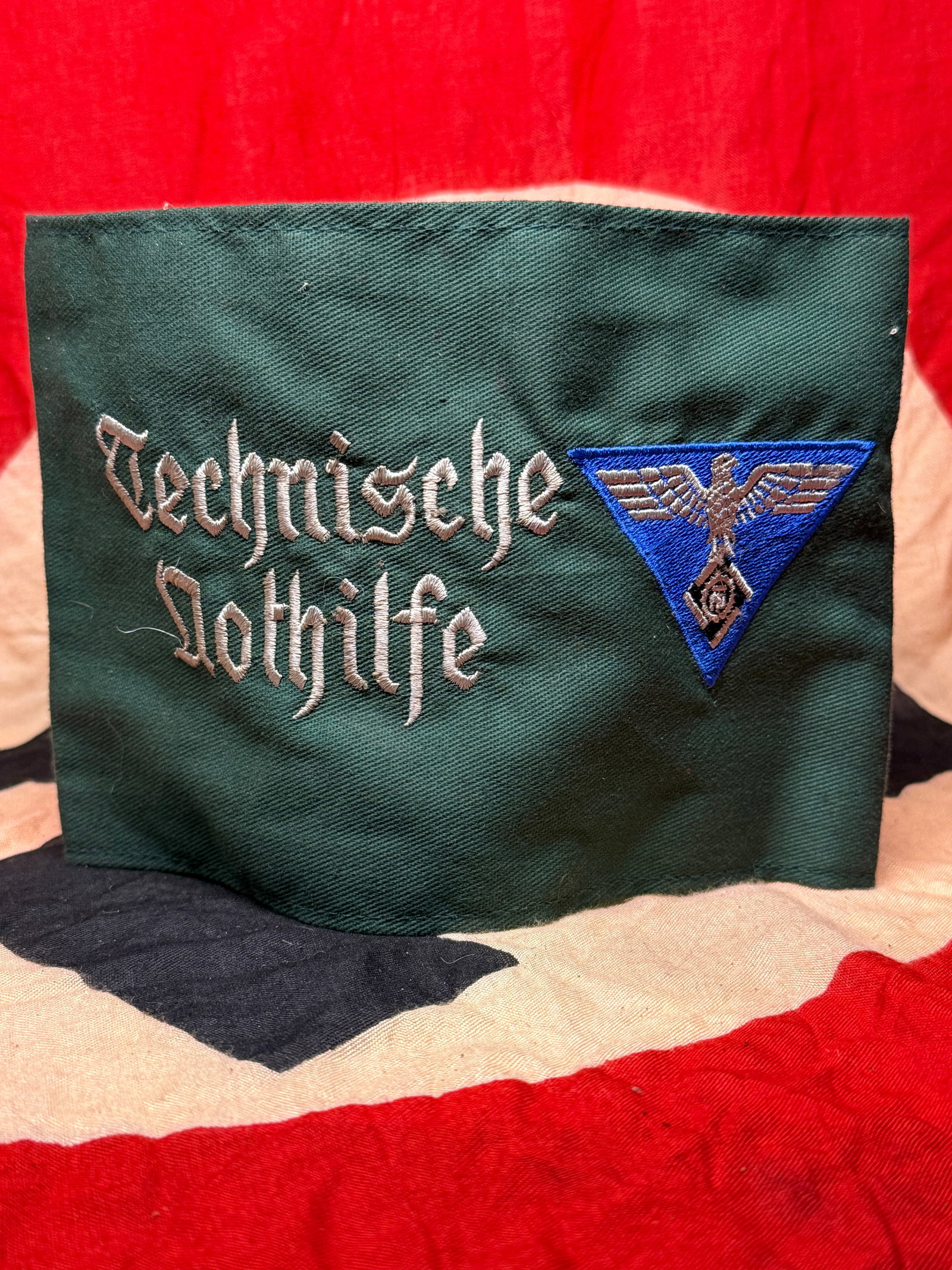 WWII Technische Nothilfe (Technical Emergency Corps) Armband: This dark green armband bears the embroidered insignia and title of the Technische Nothilfe (Technical Emergency Corps), a German organization responsible for maintaining and restoring critical infras