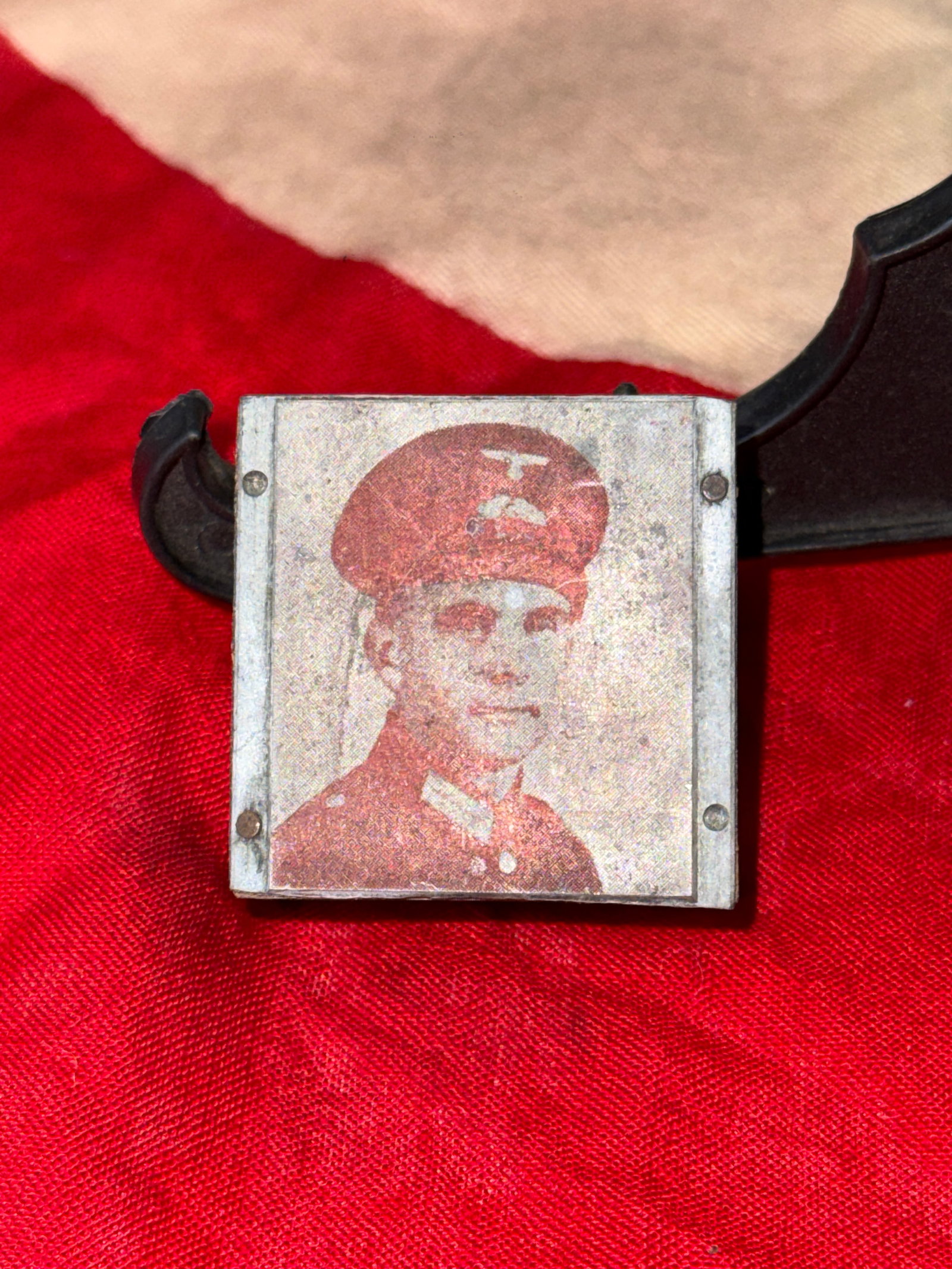 WWII German Hitler Youth Portrait Plaque: This small rectangular plaque features a printed portrait of a Hitler Youth member wearing the organization's distinctive uniform and cap with the HJ diamond insignia. Mounted within a simple metal fr
