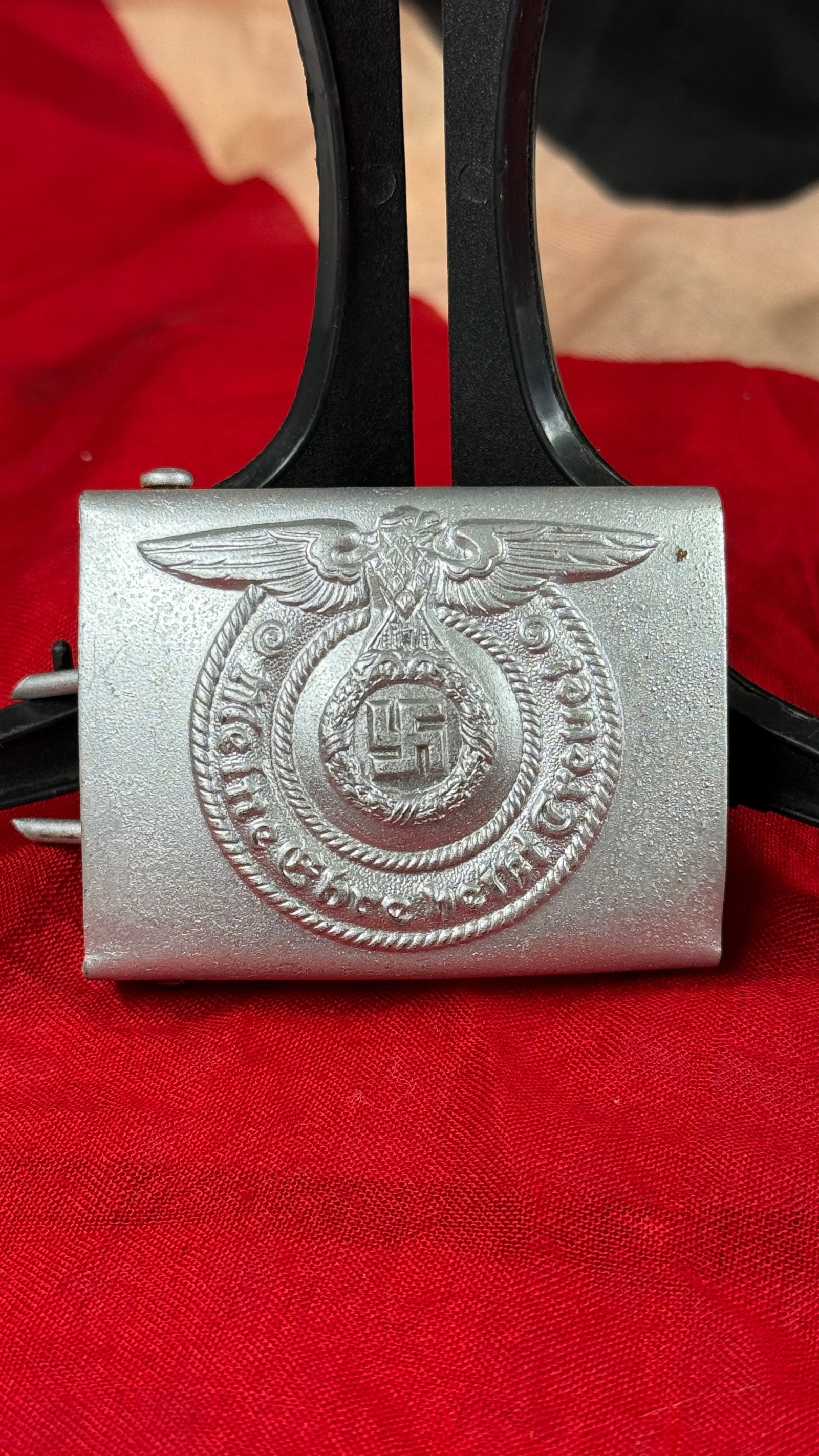 WWII German Waffen-SS Enlisted Men's (EM/NCO) Belt Buckle – RZM M4/55: This WWII German Waffen-SS enlisted men's aluminum belt buckle features the national eagle above a wreath enclosing the swastika with the SS motto "Meine Ehre heißt Treue" ("My Honor is Loyalty") sur
