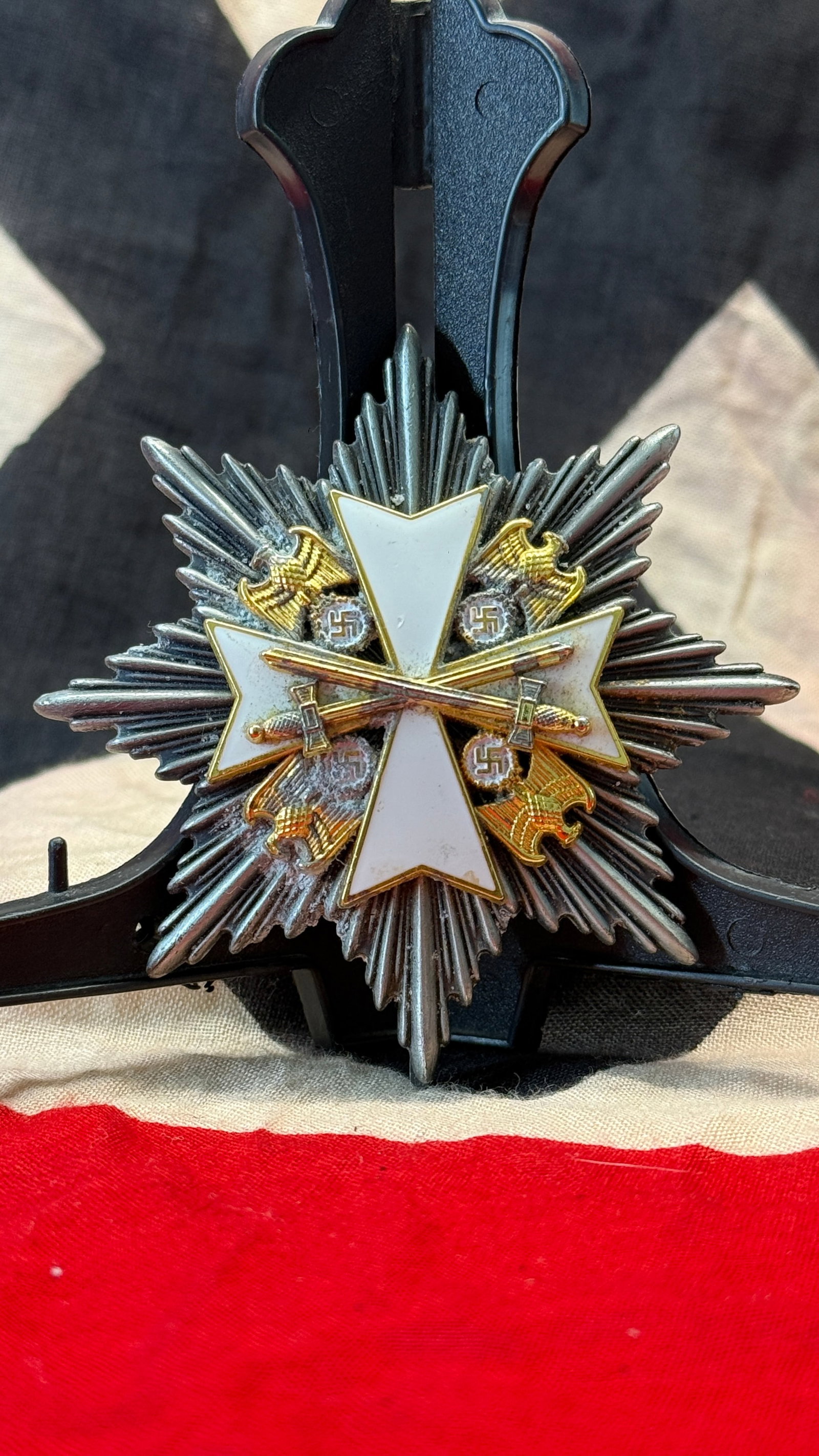 WWII German Grand Cross of the Order of the German Eagle Breast Star with Swords: This large eight-pointed silver breast star features the white enameled cross of the Order of the German Eagle with crossed gilt swords at its center. Instituted in 1937, the Order of the German Eagle