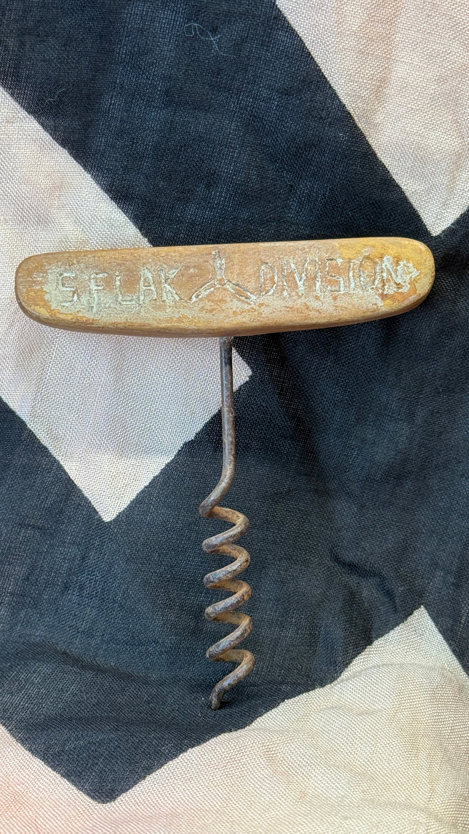 WWII German Luftwaffe 1 / Flak Division Corkscrew: This military corkscrew features a brass handle engraved "S. Flak Division" on one side and "Luftwaffe 1" on the other, identifying its association with a German anti-aircraft formation assigned to Lu