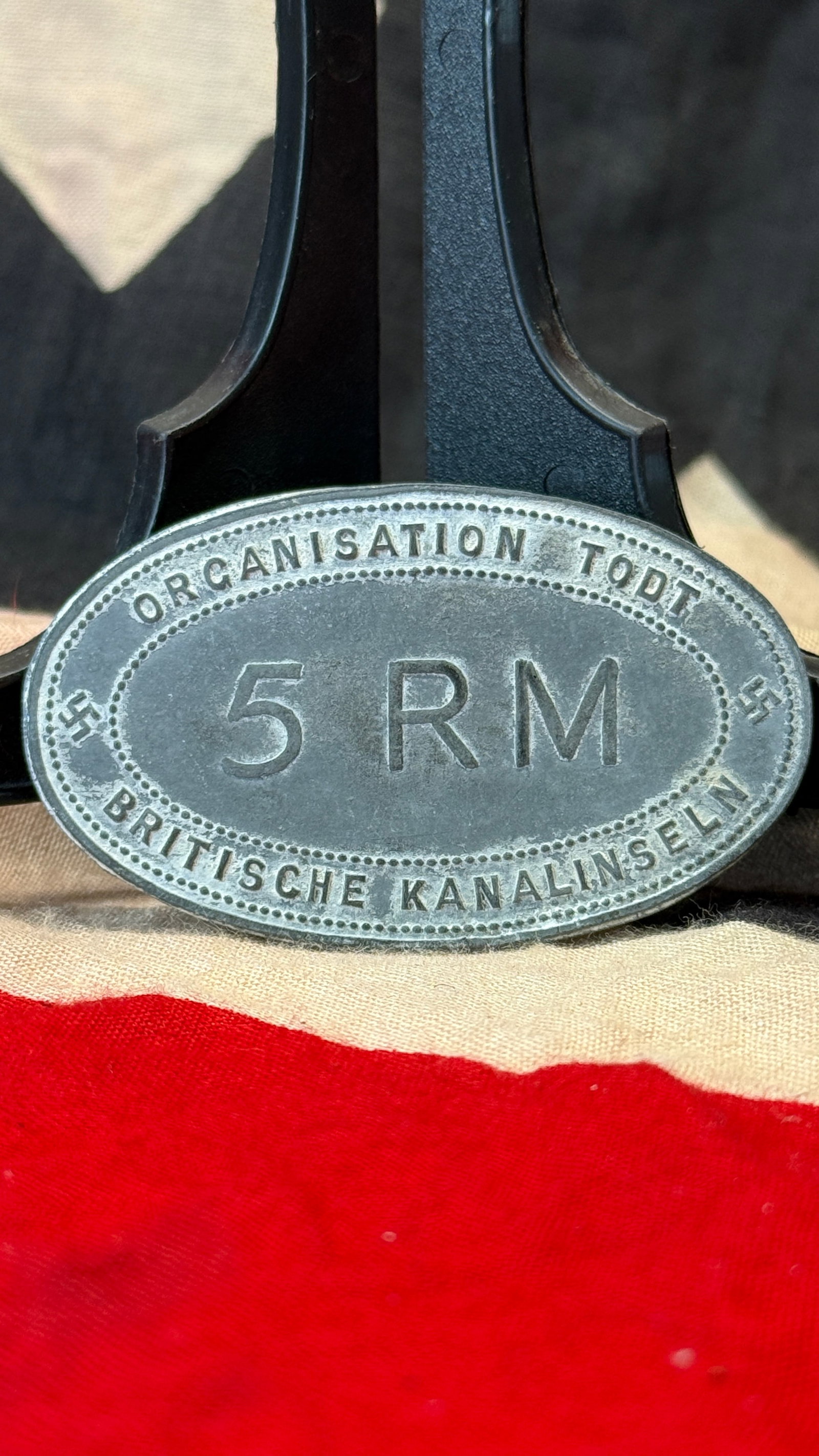 WWII German Organisation Todt British Channel Islands 5 RM Scrip Token: This oval metal token is engraved "Organisation Todt," "Britische Kanalinseln," and the denomination "5 RM," identifying it as a payment or canteen token associated with the Organisation Todt in the B