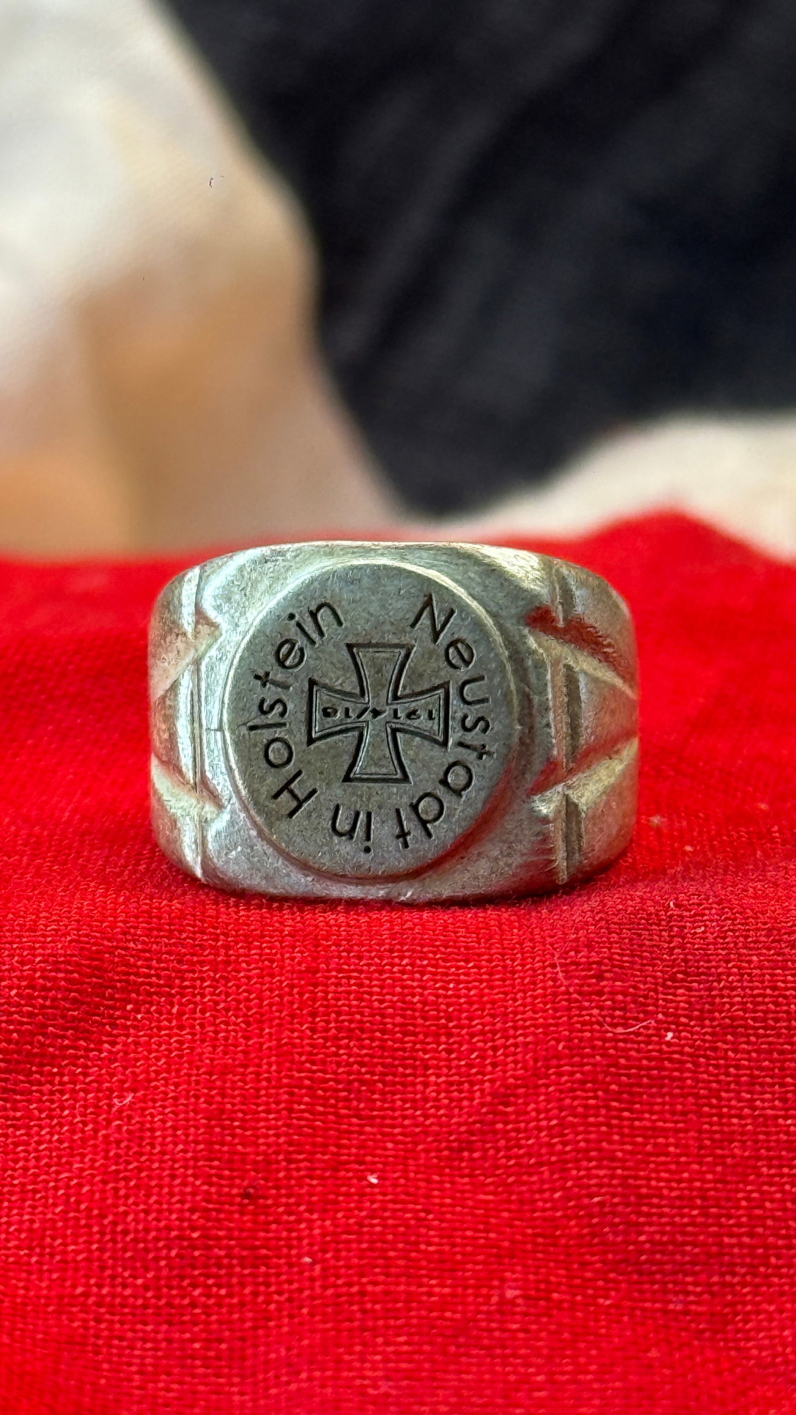 WWII German "Ein Volk, Ein Reich, Ein Führer" Patriotic Ring: This cast metal ring features an Iron Cross at its center surrounded by the inscription "Ein Volk, Ein Reich, Ein Führer" ("One People, One Reich, One Leader"), a well-known political slogan of Nazi 