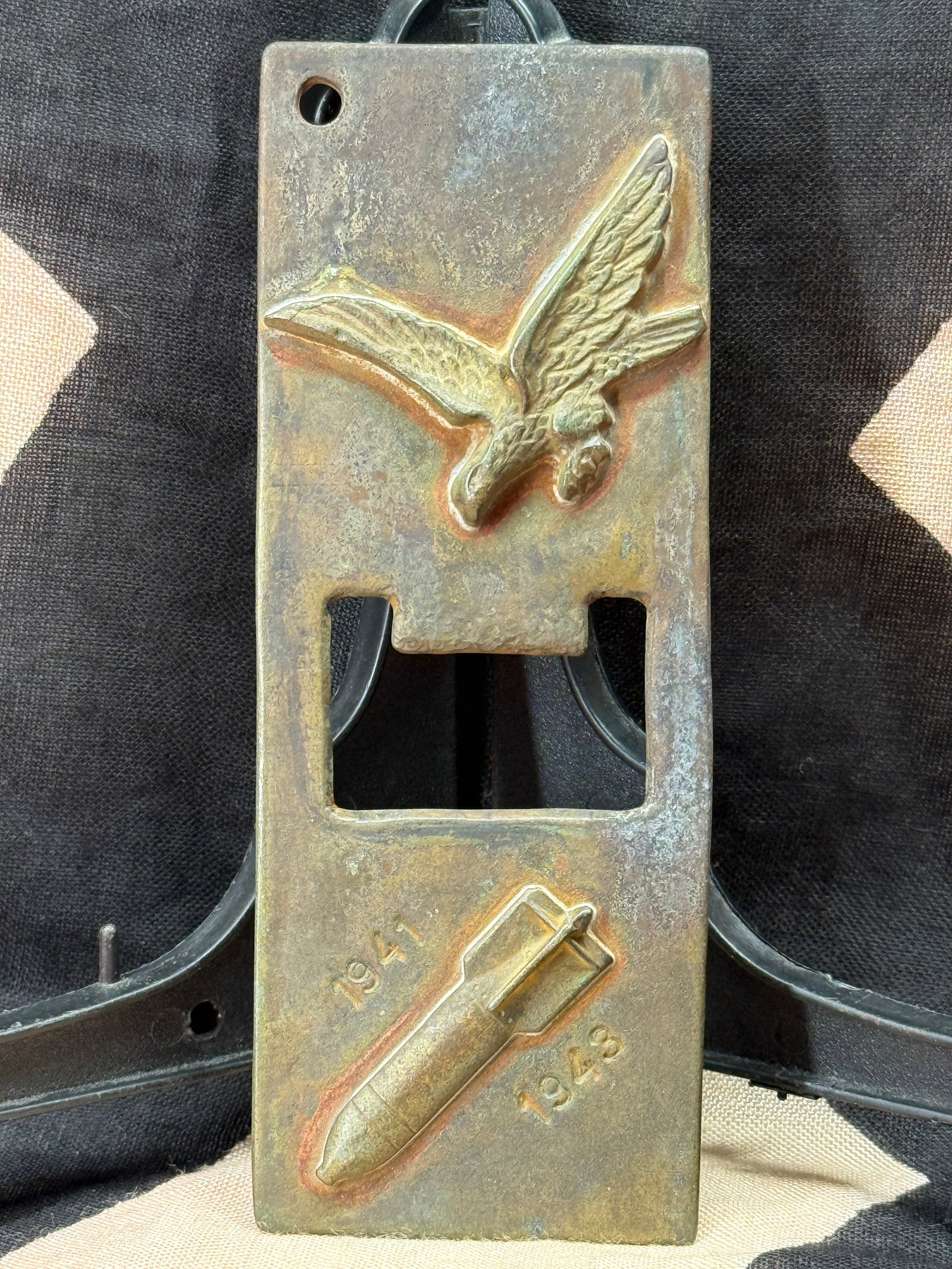 WWII German Luftwaffe Belt Buckle Casting Mold: This heavy metal mold features a raised Luftwaffe eagle on one end and a bomb motif marked "1941" and "1943" on the opposite end, with a central rectangular opening corresponding to the profile of a L
