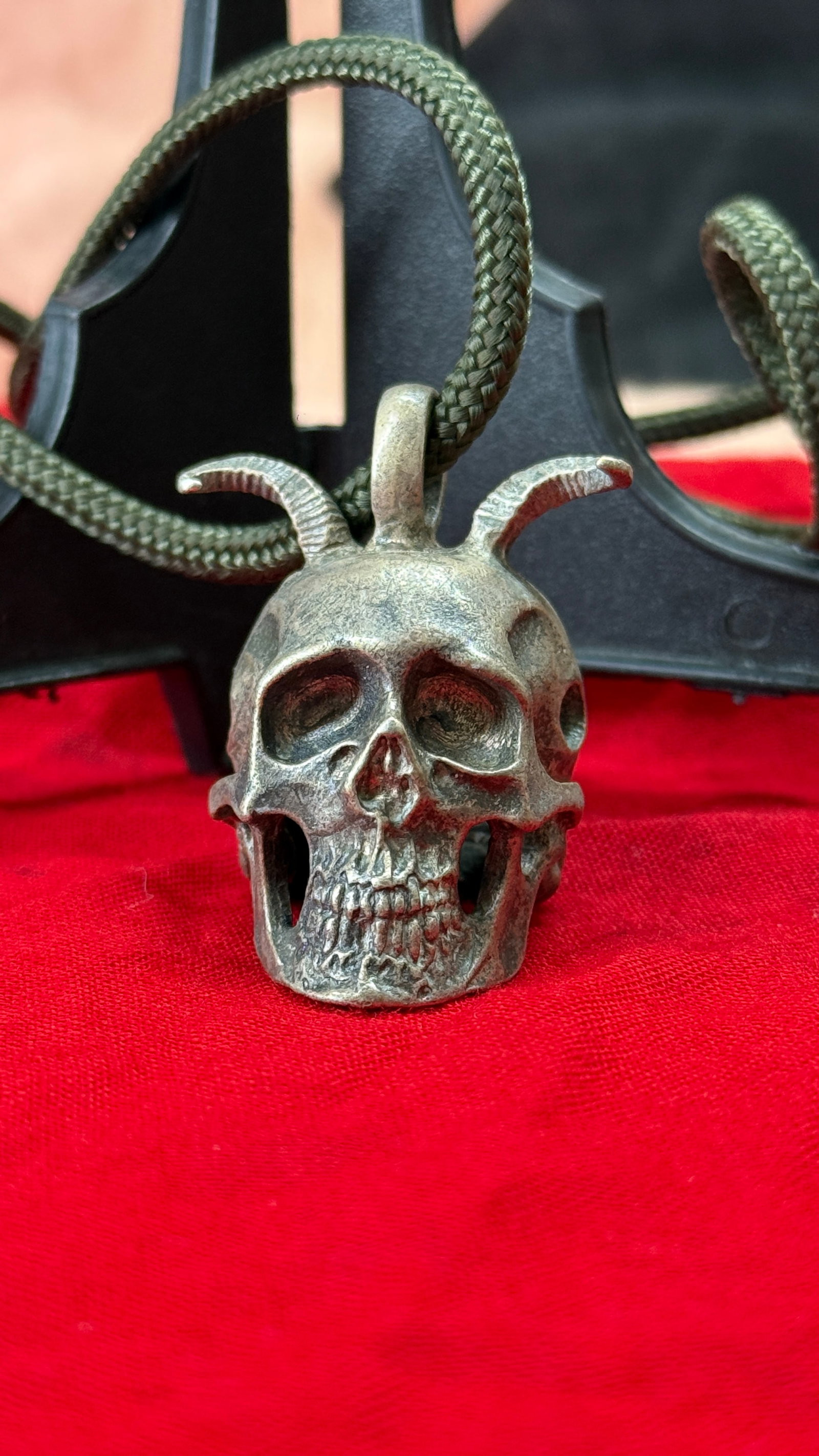 WWII German SS Totenkopf Officer Skull Pendant: This cast metal pendant depicts the iconic SS Totenkopf (Death's Head) skull with finely detailed facial features, open eye sockets, pronounced teeth, and a suspension loop at the crown for wear as a 