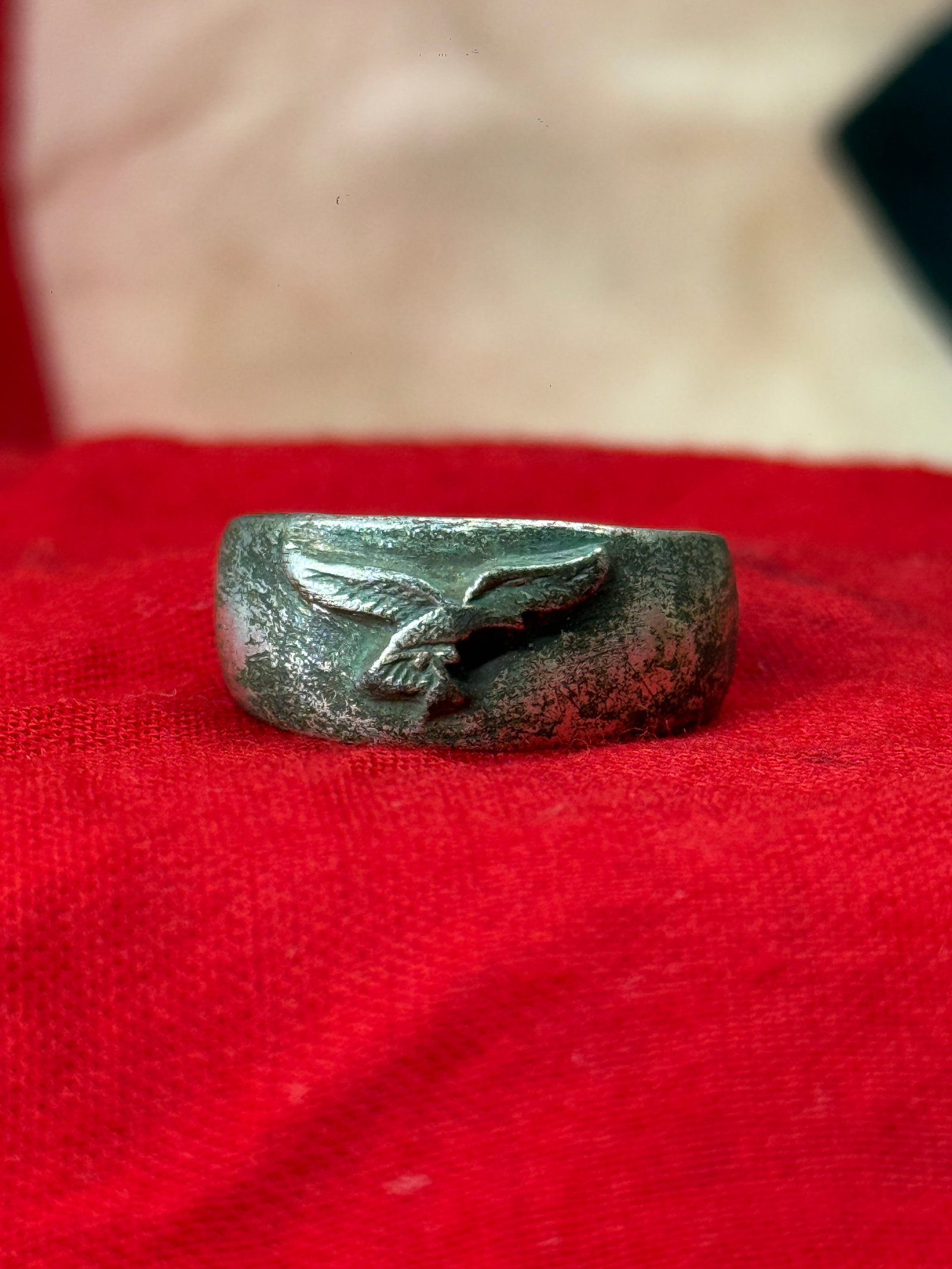 WWII German Luftwaffe Eagle Pilot Field Worn Ring: This World War II German ring features a raised Luftwaffe-style eagle in flight prominently displayed across the front of a solid cast band with a dark aged finish. The simple yet recognizable militar