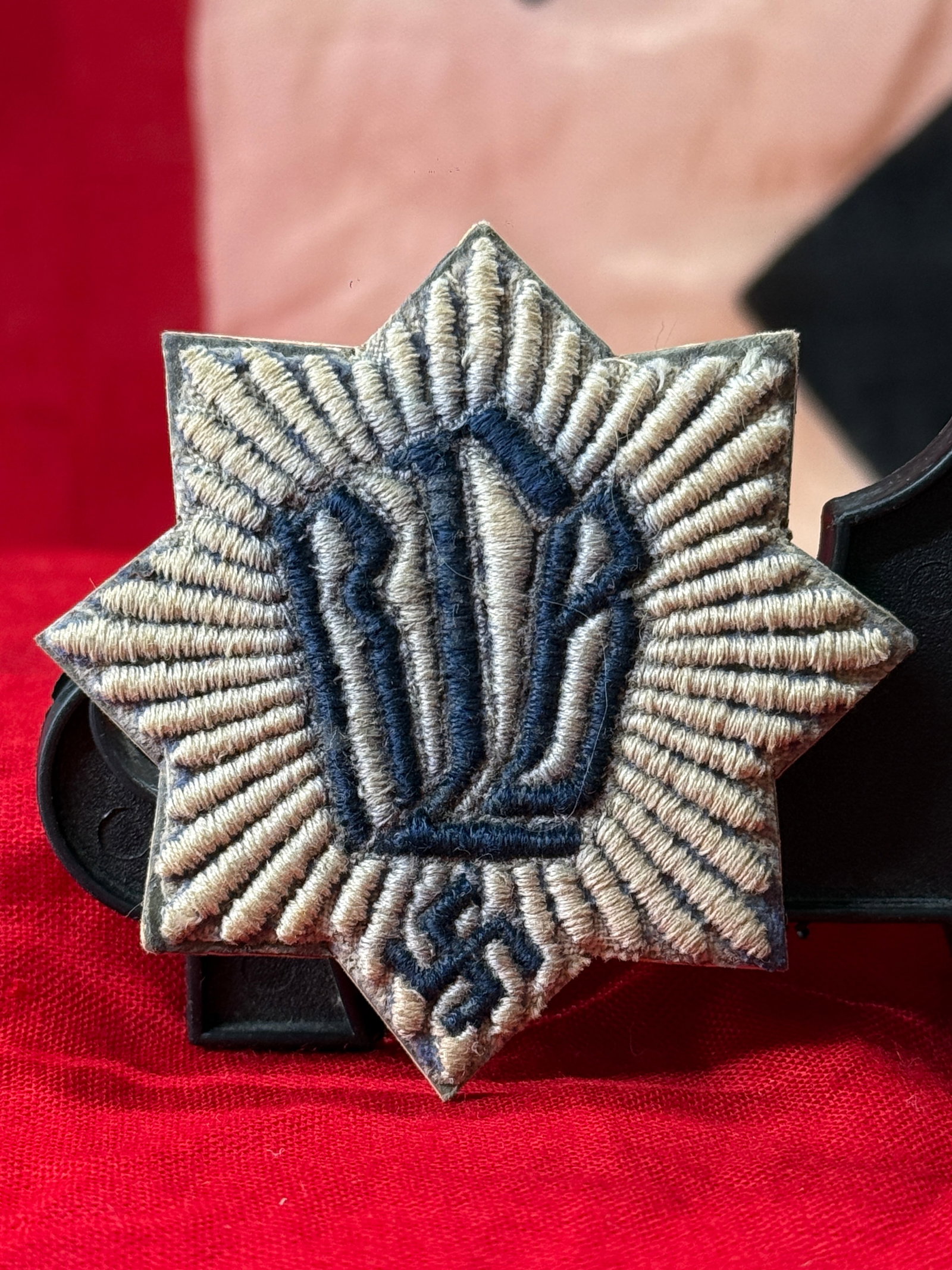 WWII German Reichsluftschutzbund (RLB) 1st Pattern Membership Badge: This World War II German Reichsluftschutzbund (RLB) 1st Pattern membership badge is embroidered in silver-gray and dark blue thread on an eight-pointed star-shaped cloth backing. The center displays t