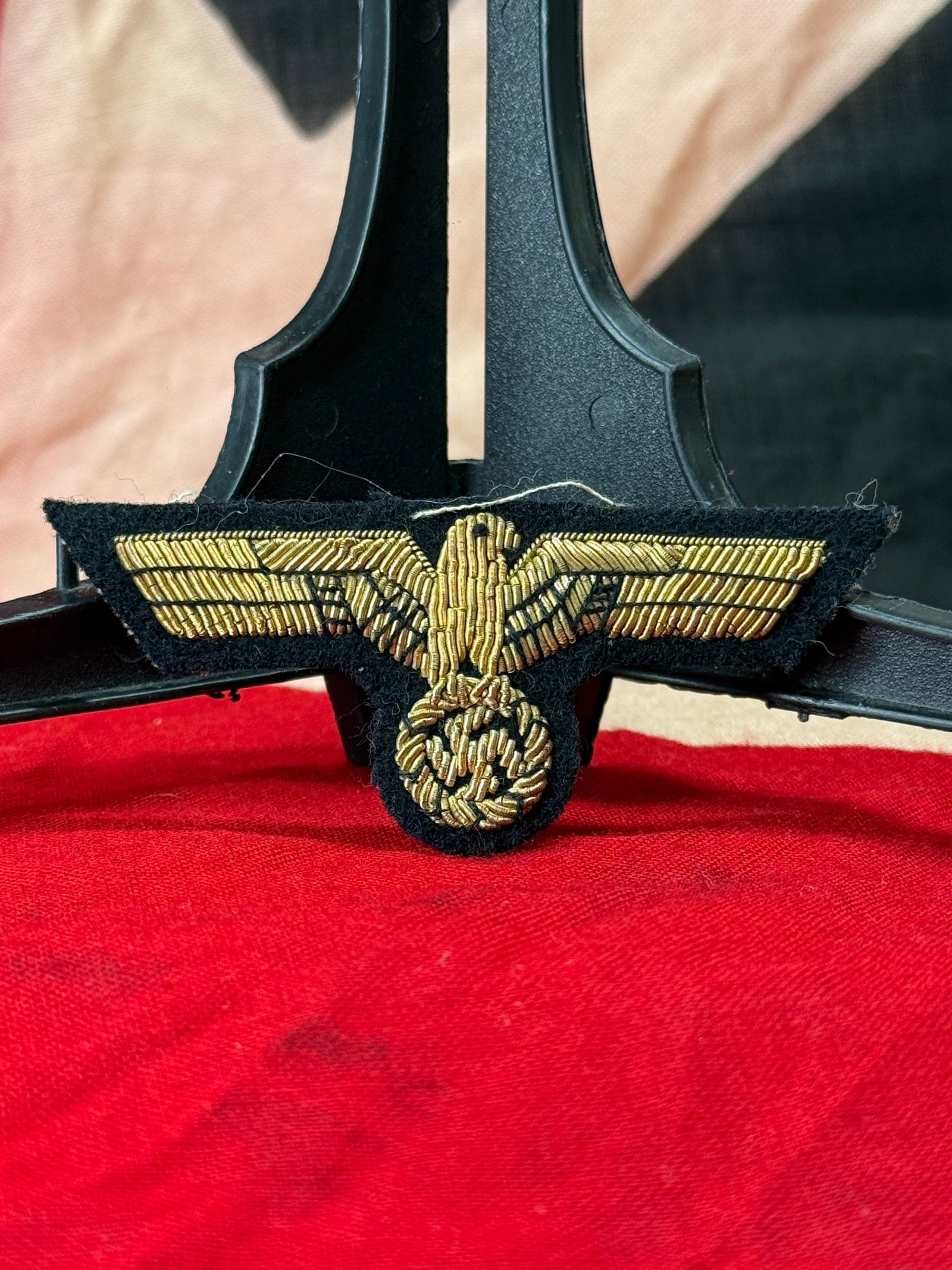 WWII German NSDAP Political Leader Bullion Breast Eagle: This WWII German NSDAP Political Leader breast eagle insignia is executed in finely hand-embroidered gilt bullion wire on a black wool backing. The design features the national eagle with outstretched