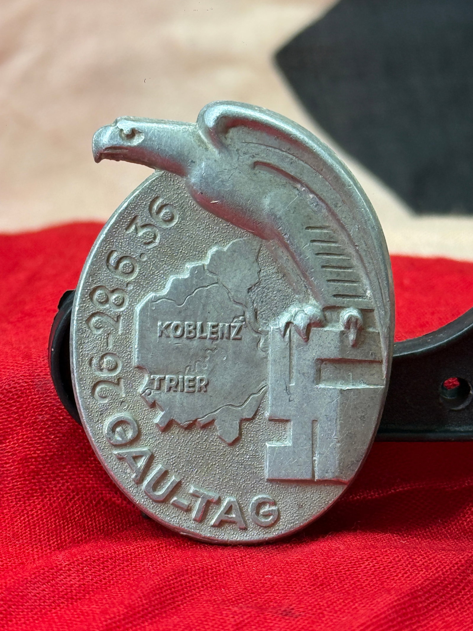 WWII German Gautag Koblenz–Trier 26–28 June 1936 Tinnie: This aluminum tinnie commemorates the Gautag held in the Koblenz–Trier district from 26–28 June 1936. The obverse depicts a stylized national eagle above a map identifying Koblenz and Trier, accom