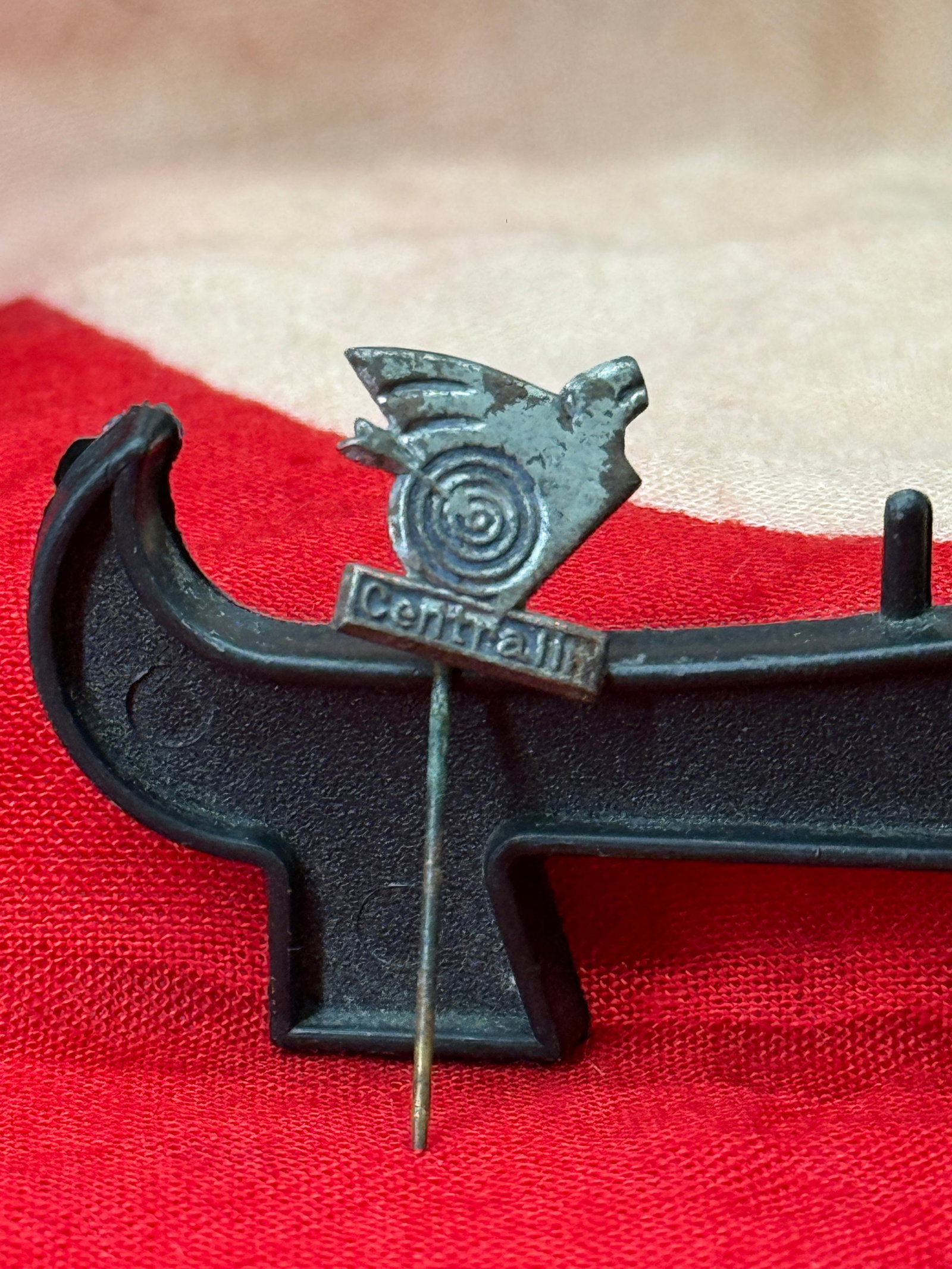 WWII German “Der Stahlhelm?? Cerff-Kamm Stickpin: This small enameled and silvered stickpin bears the inscription "Cerff-Kamm" beneath a stylized steel helmet, spiral target, and projectile motif. The design is associated with promotional advertising