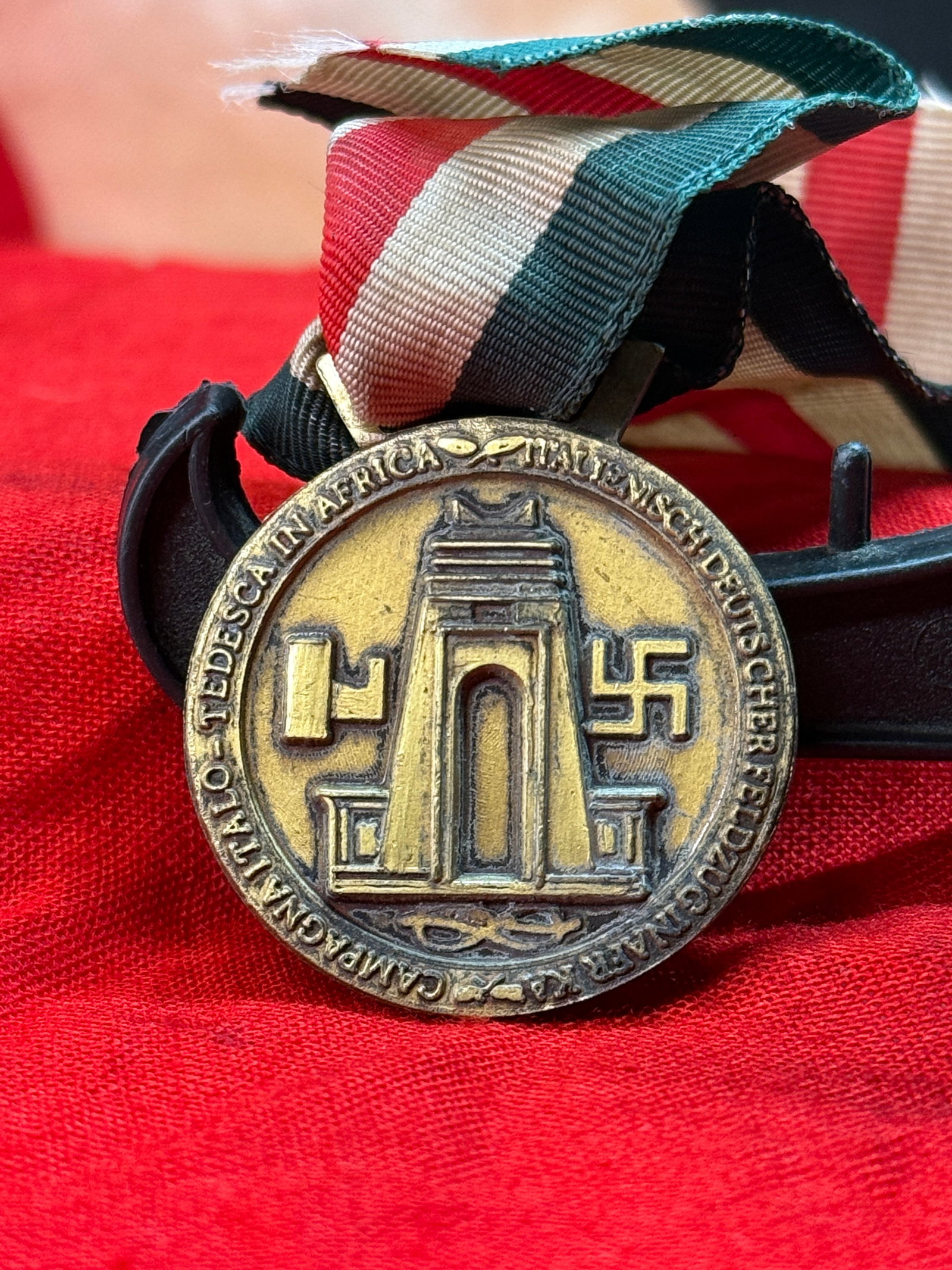 WWII German–Italian Campaign in Africa Medal: Instituted in 1942, the German–Italian Campaign in Africa Medal commemorated German and Italian personnel who served in the North African Campaign. The obverse depicts a palm tree rising above milit
