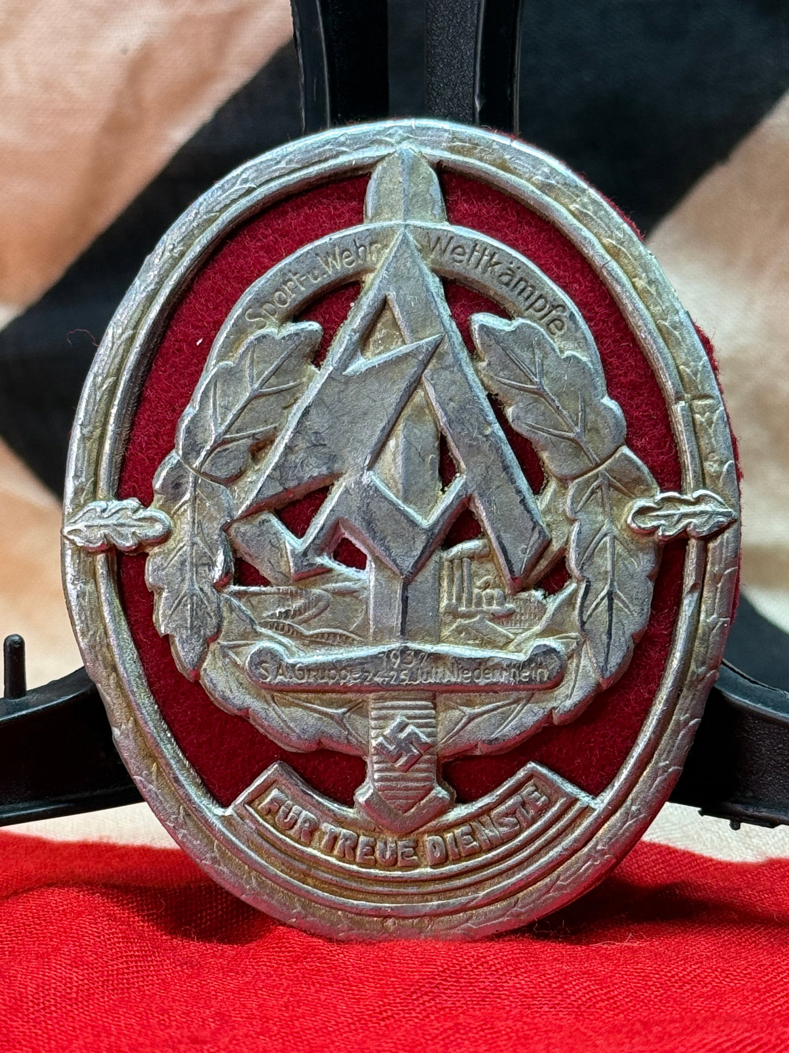 WWII German SA Sports Badge (SA-Sportabzeichen): This oval metal badge features the prominent SA runes surrounded by an oak leaf wreath with the inscriptions "Sport-Wehr Wettkämpfe" across the top, "SA-Gruppe Südwest Kurpfalz-Saar" on the central 