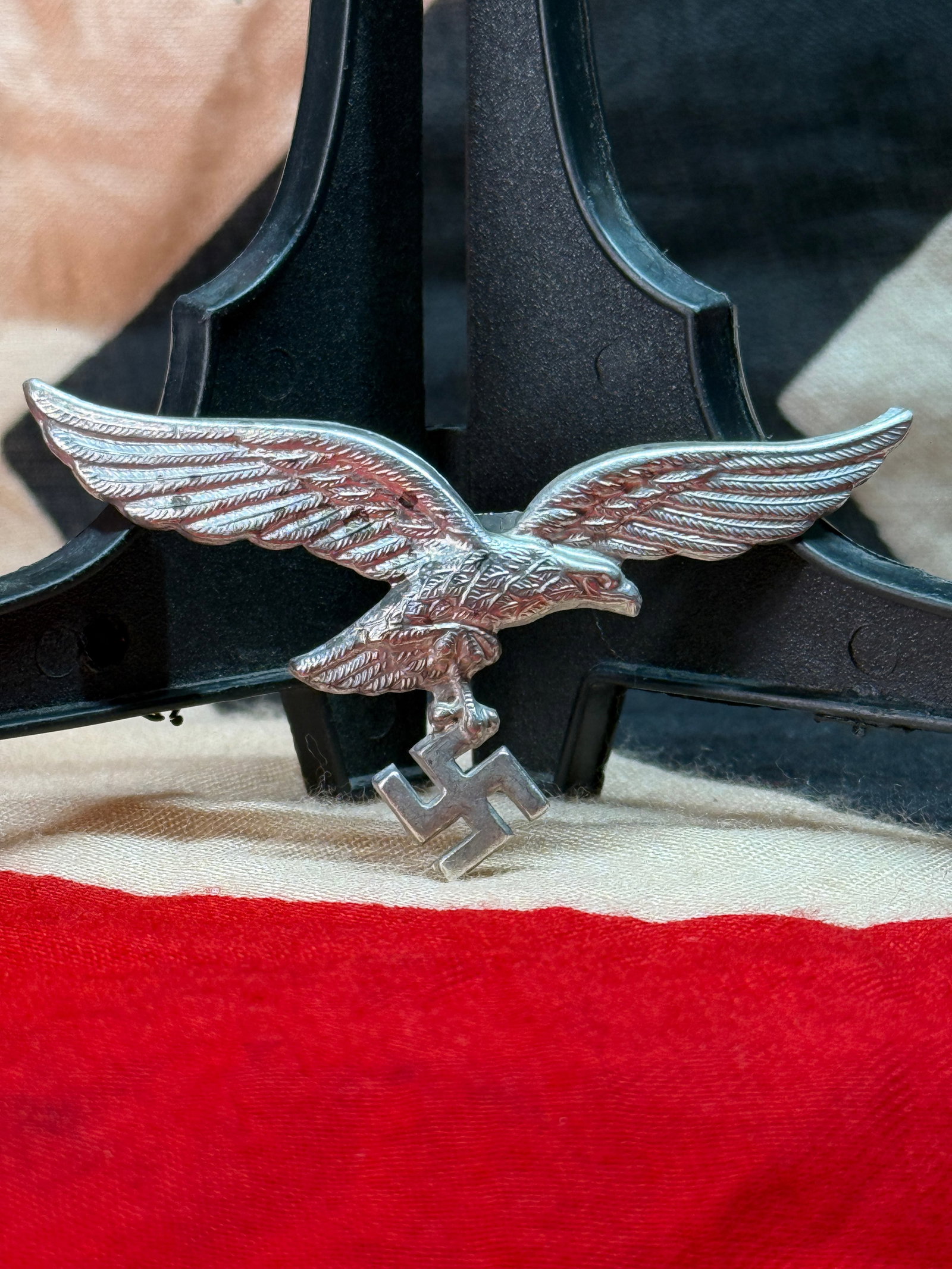 WWII German Luftwaffe Cap Eagle Insignia: This stamped metal eagle depicts the outstretched Luftwaffe eagle clutching a swastika within its talons, one of the most recognizable insignia worn by personnel of the German Air Force during the Sec