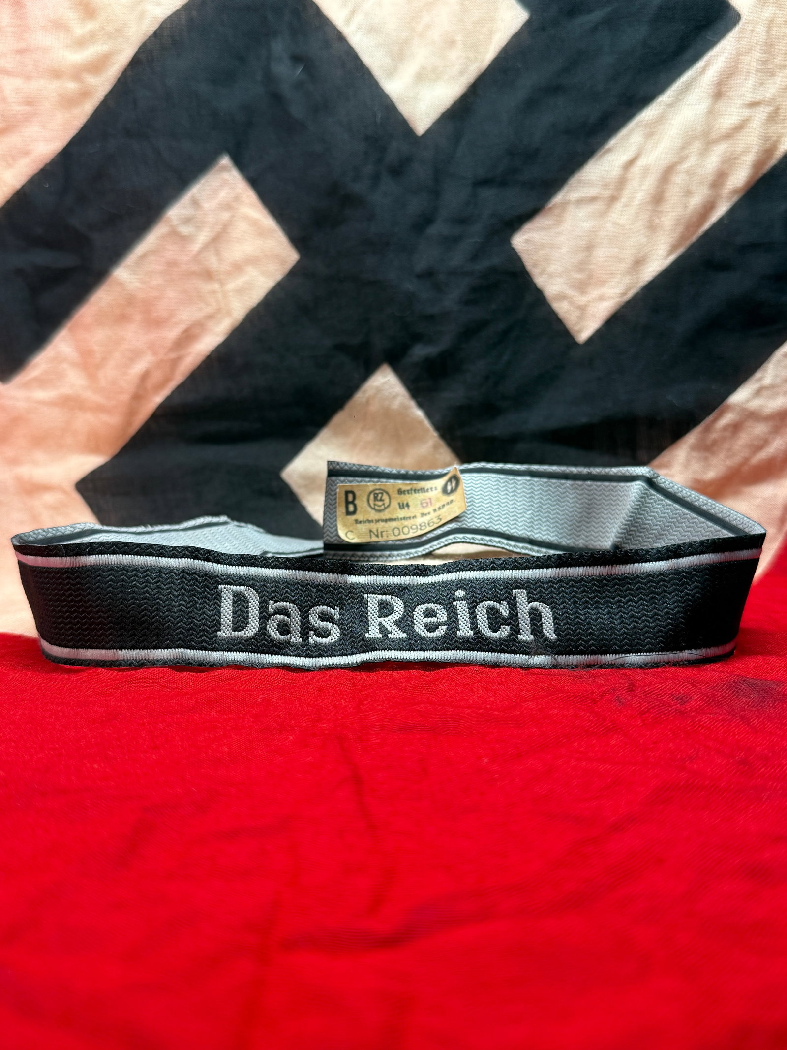 WWII German Waffen-SS "Das Reich" Cuff Title with RZM Control Label: This woven cuff title bears the embroidered inscription "Das Reich," identifying the famed 2nd SS Panzer Division "Das Reich." The interior retains an RZM (Reichszeugmeisterei) control label displayin