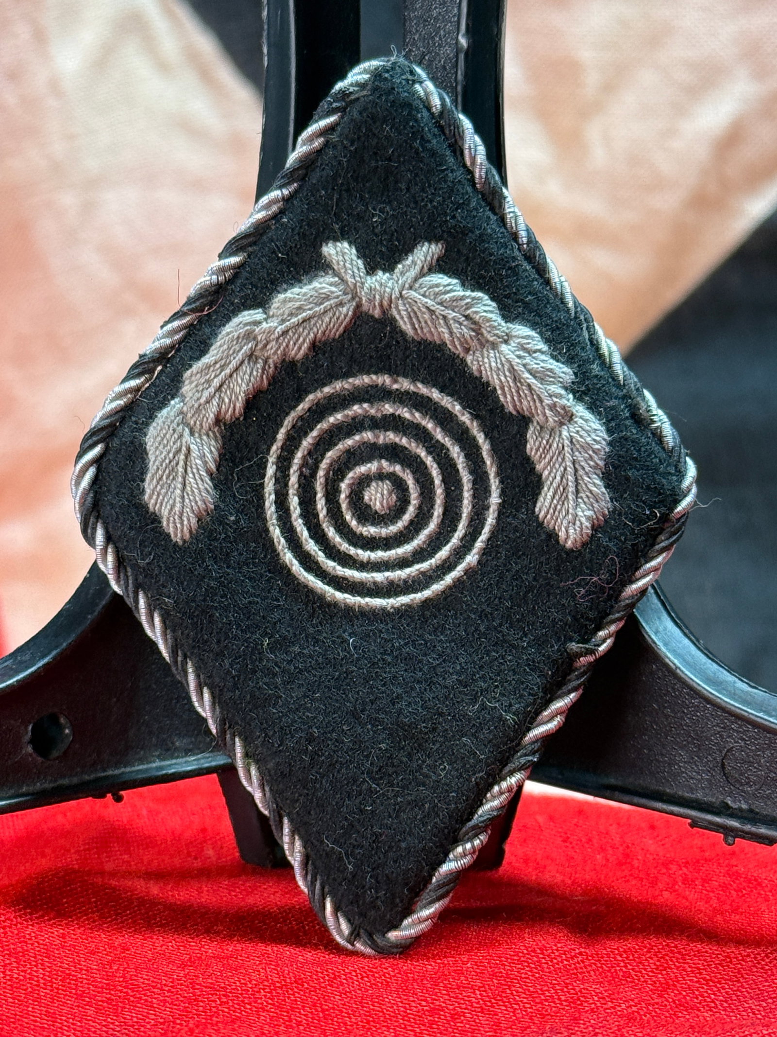 WWII German Heer Marksmanship (Schützenschnur) Sleeve Diamond: This black wool sleeve diamond is embroidered with a concentric target beneath a laurel wreath and finished with twisted silver bullion piping around the border. Insignia of this pattern served as the