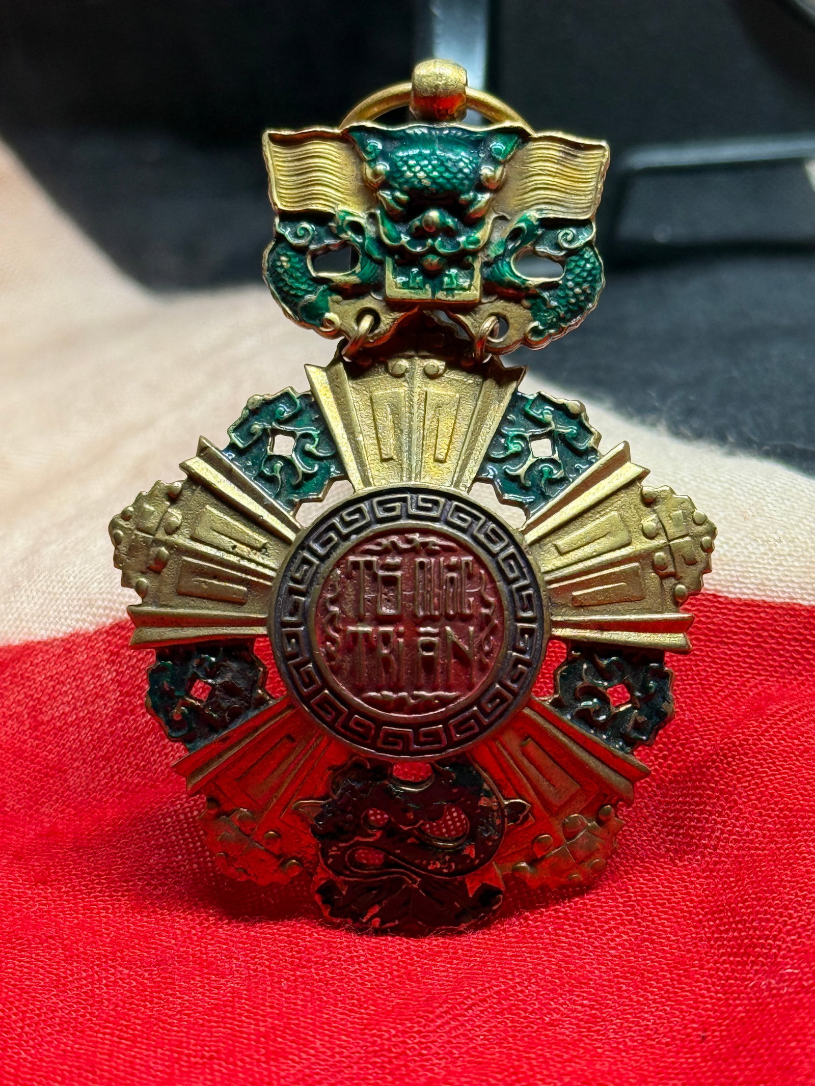 Republic of Vietnam National Order Medal – 5th Class: This medal is the Republic of Vietnam National Order, 5th Class (Knight), distinguished by its elaborate multi-pointed star, colorful enamel work, dragon motifs, and central medallion bearing Sino-Vie