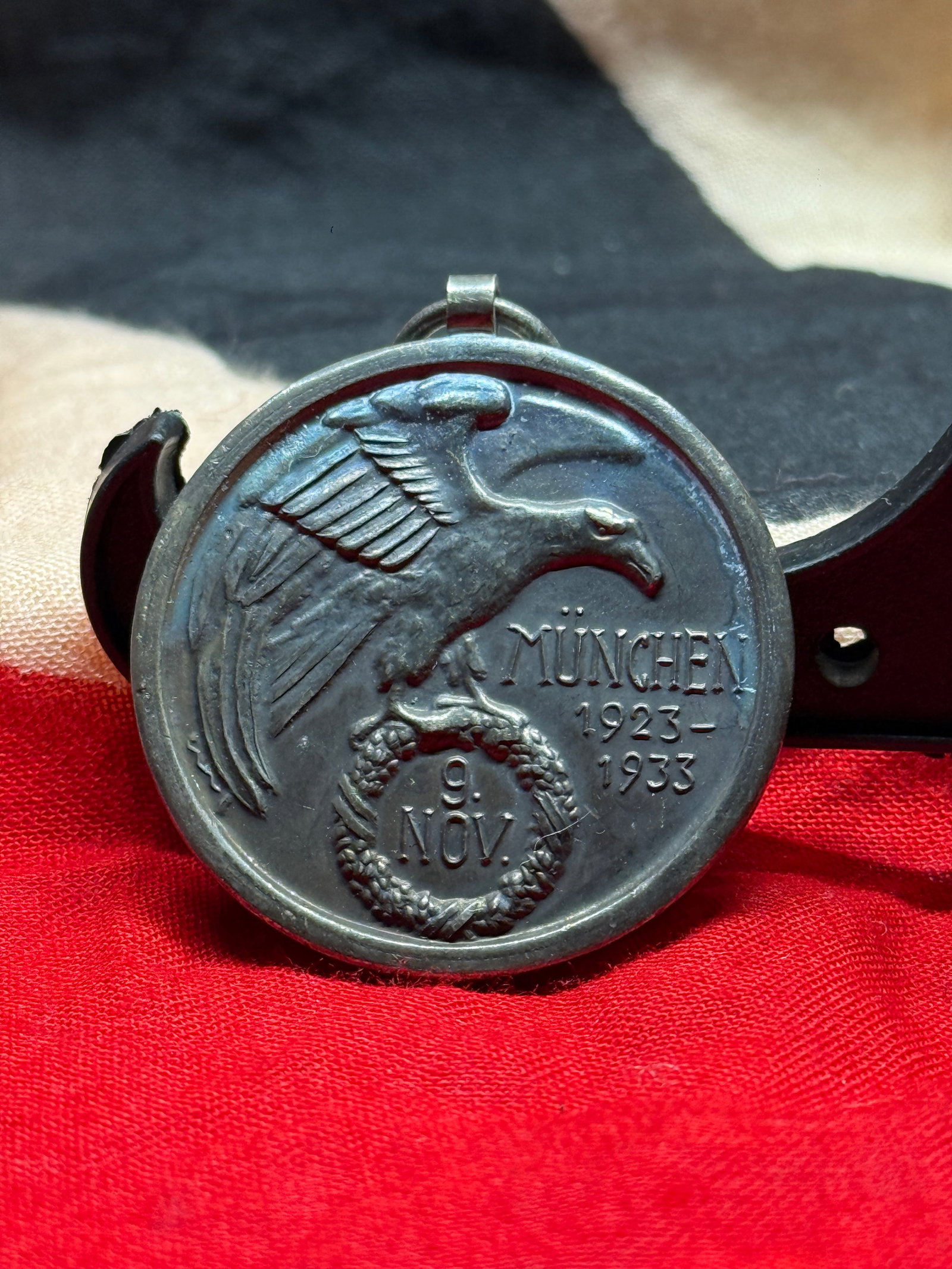 WWII German Munich 1923–1933 Commemorative Medal: This commemorative medal honors the tenth anniversary of the Munich Beer Hall Putsch of November 9, 1923. One side depicts an eagle above a wreath enclosing the date "9. Nov." alongside the inscriptio