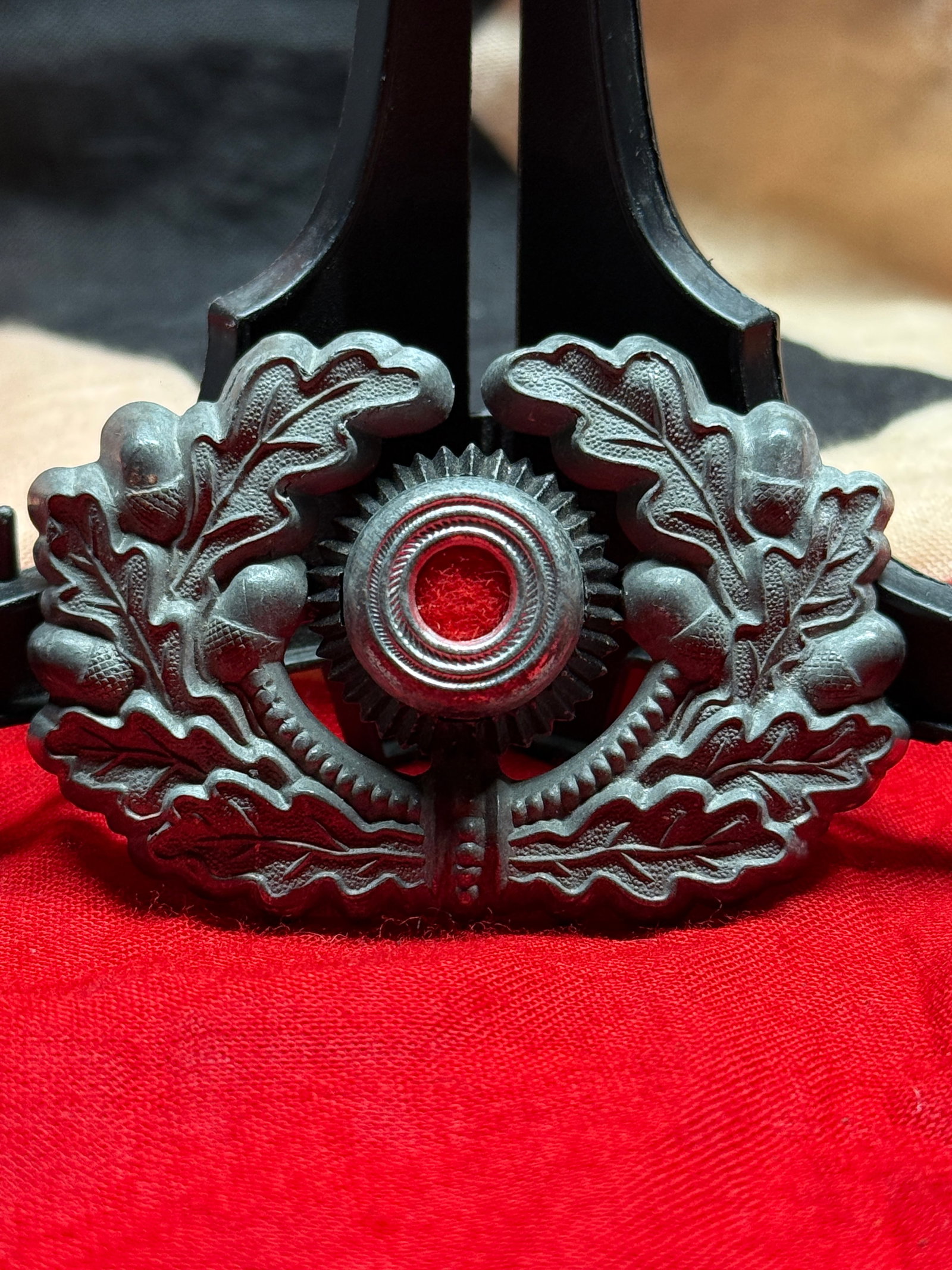 WWII German Heer Army Officer Visor Cap Wreath and Cockade Insignia: This WWII German Heer Army Officer Visor Cap Wreath and Cockade Insignia features the classic oak leaf and acorn wreath surrounding the national cockade with a black, white, and red center. Constructe