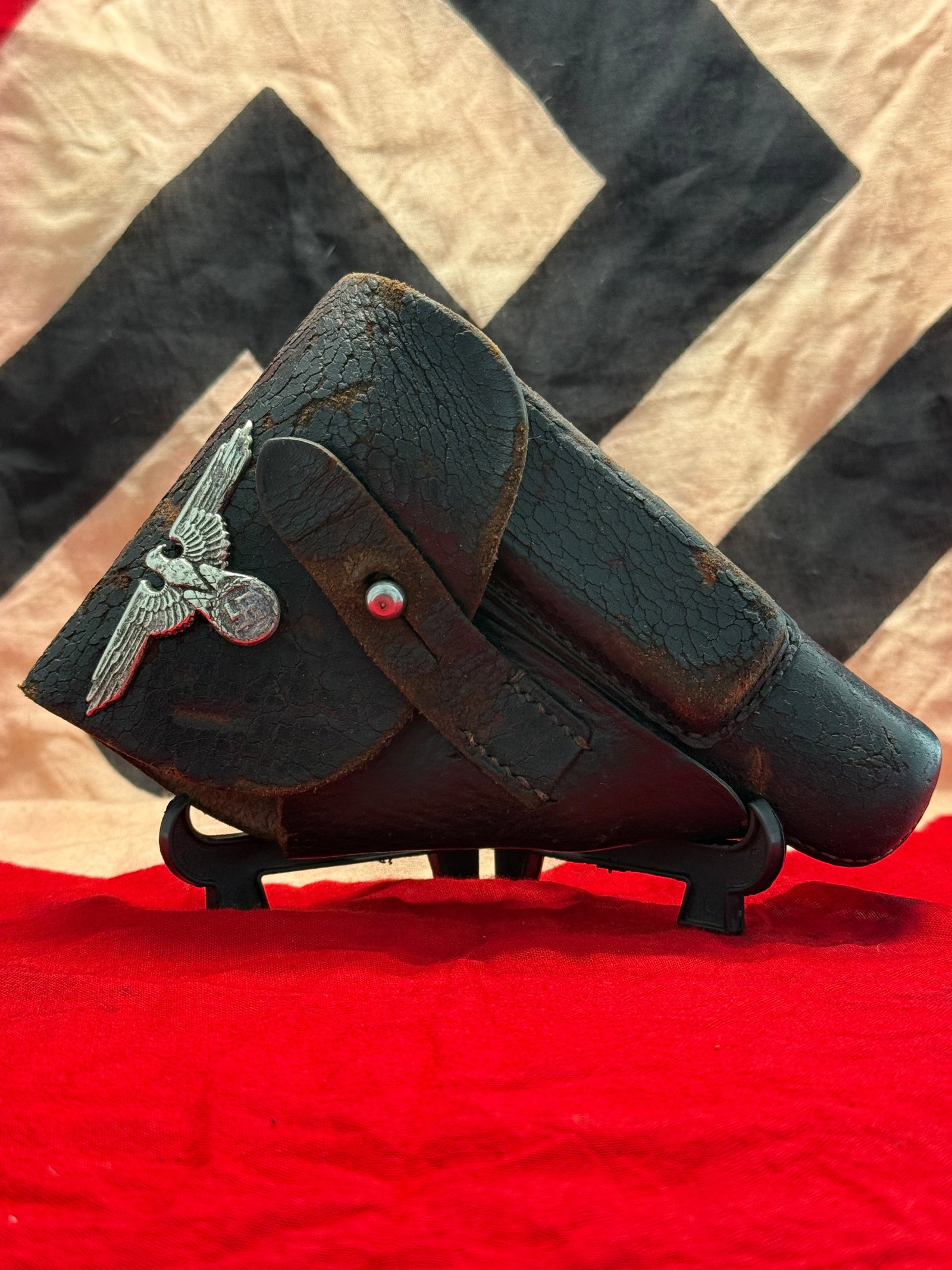 WWII German Waffen-SS Officer Leather Pistol Holster with SS Eagle: This WWII German Waffen-SS Officer leather pistol holster is constructed of black leather and features a silver-colored Waffen-SS eagle affixed to the front flap. The holster retains its full flap clo