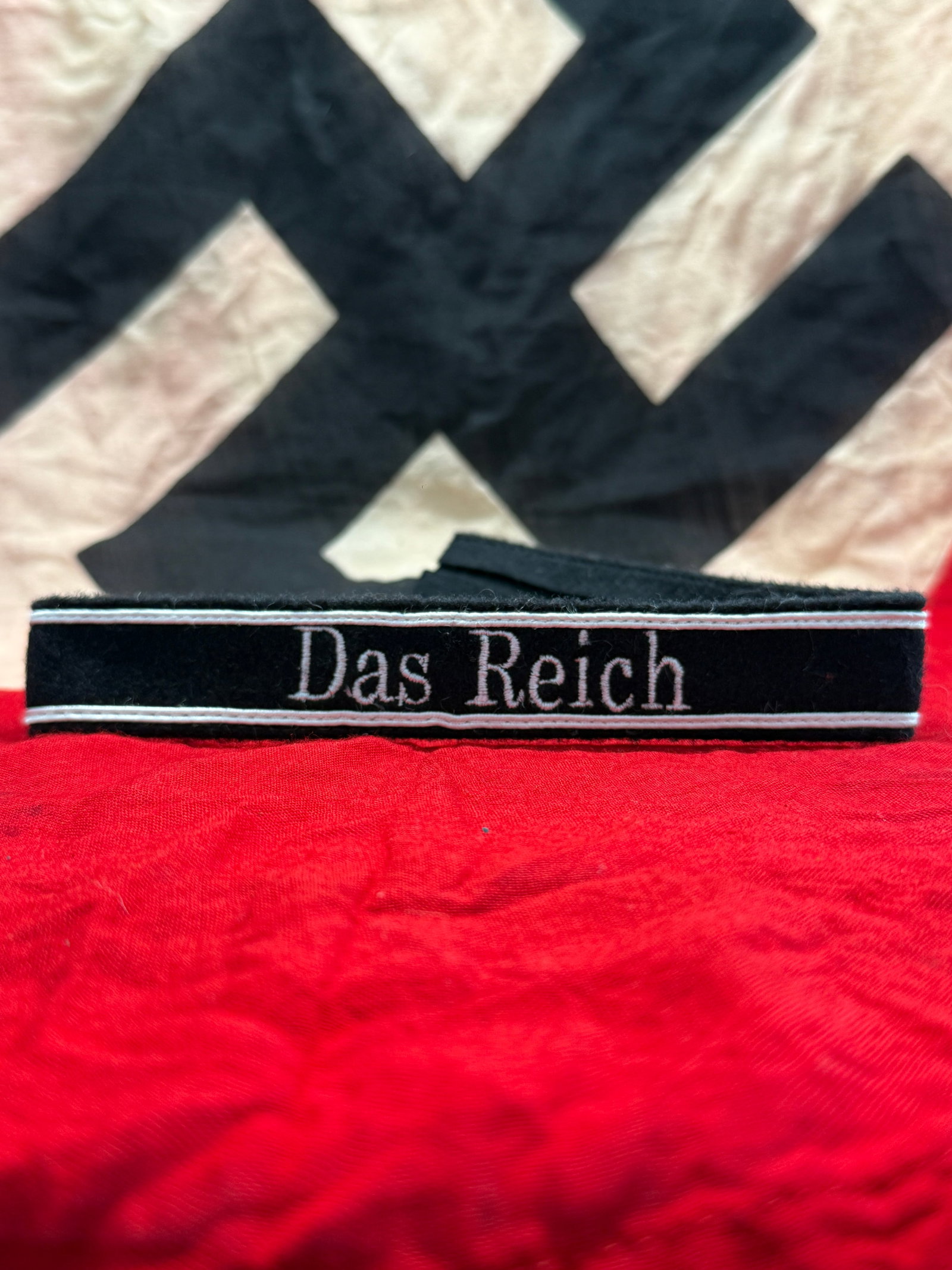 WWII German Waffen-SS “Das Reich?? Cuff Title: This black cloth cuff title is embroidered in silver-gray thread with the inscription “Das Reich,” identifying the famed 2nd SS Panzer Division Das Reich. Worn on the lower sleeve of Waffen-SS