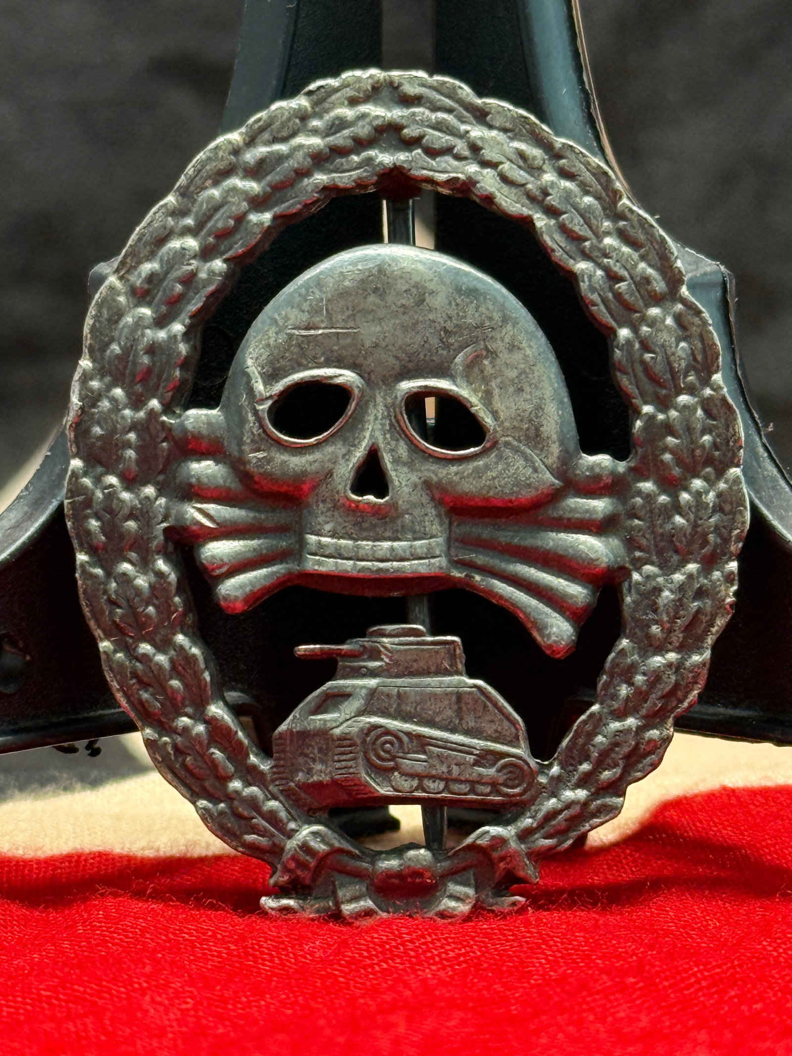 German Condor Legion Tank Badge (Spanish Civil War): This German Condor Legion Tank Badge features the distinctive design of an armored tank beneath a skull and crossbones (Totenkopf), all enclosed within an oak leaf wreath. Instituted to recognize memb