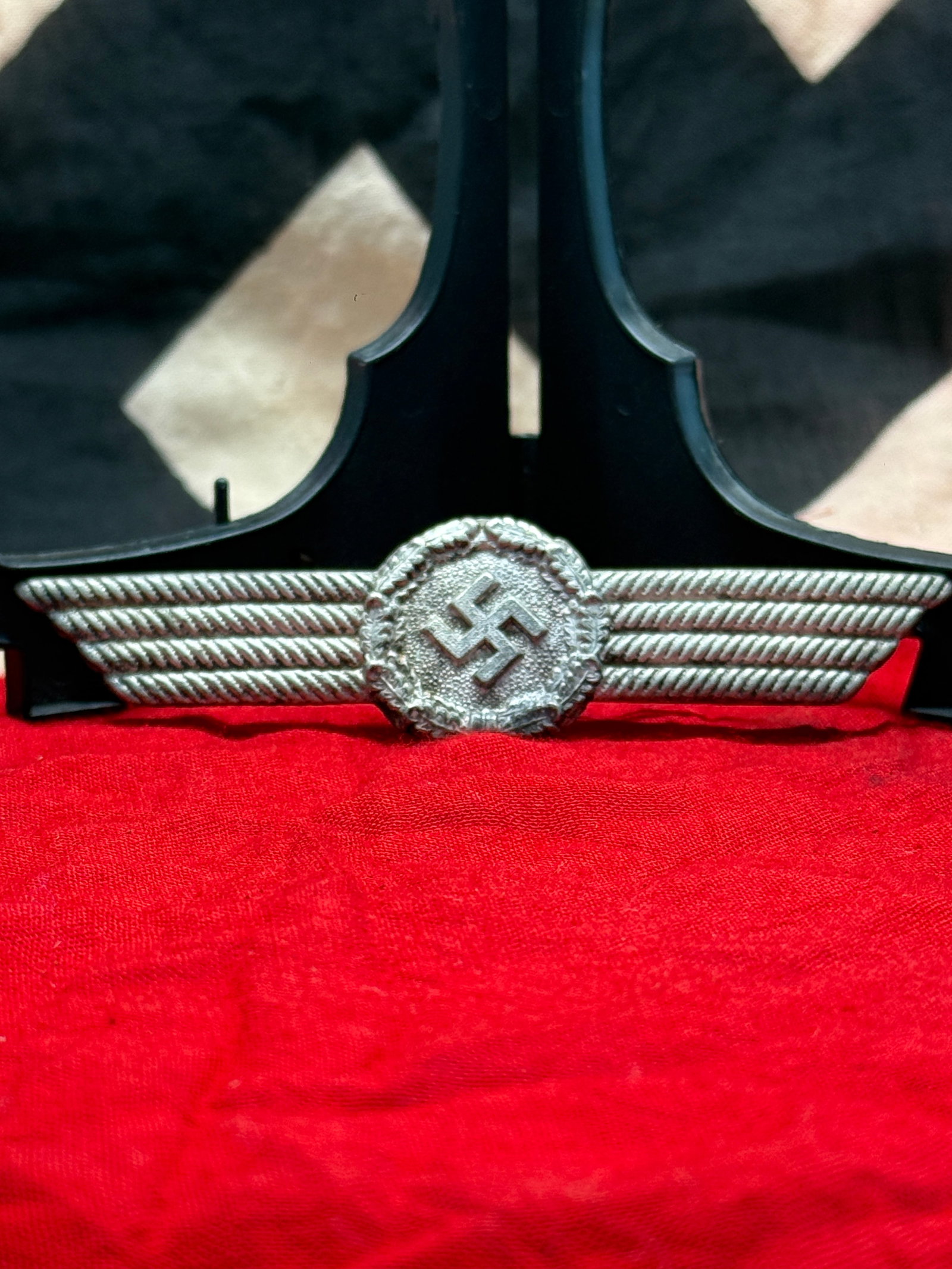 WWII German Luftwaffe Civilian Personnel Visor Cap Wreath & Cockade: This metal insignia consists of the winged wreath and central cockade worn on the visor caps of civilian personnel attached to the German Luftwaffe during the Second World War. The ribbed wings extend