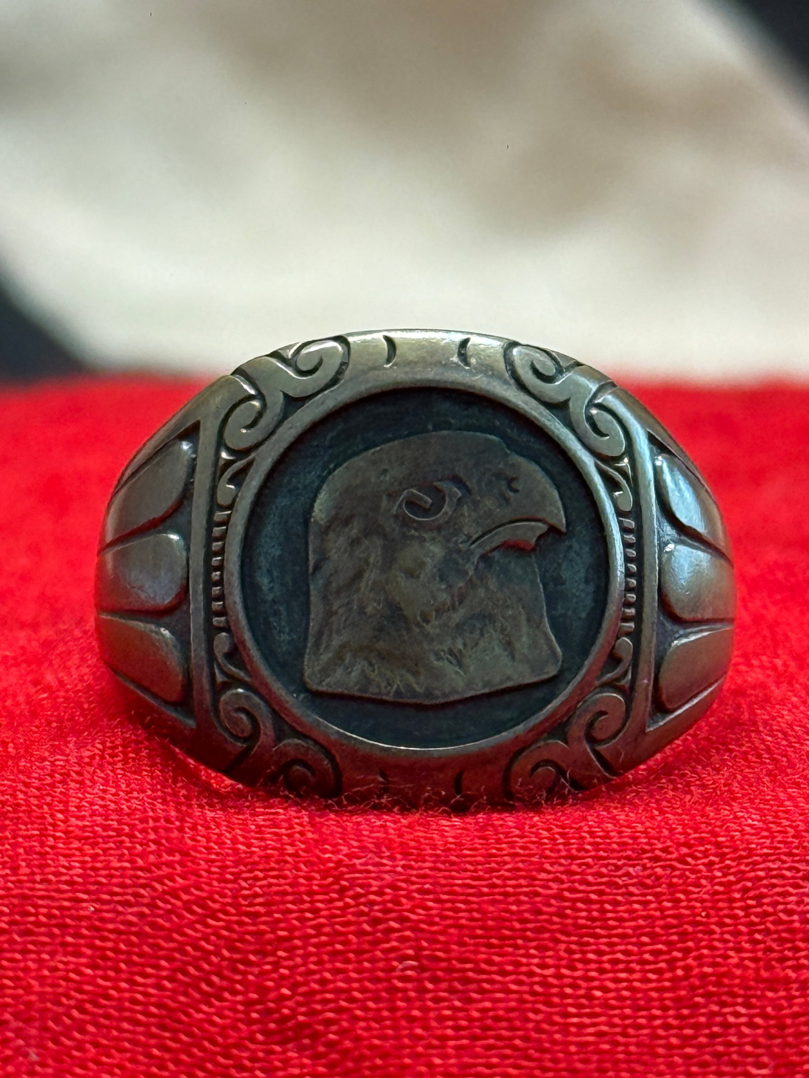 WWII German Luftwaffe Eagle Pilot's Personal Ring in 800 Silver – Greif 122 Rgt 409 W1941: This WWII German Luftwaffe pilot's personal ring is crafted in 800 silver and features a finely detailed eagle head motif set within an oval bezel, framed by decorative scrollwork and fluted shoulders