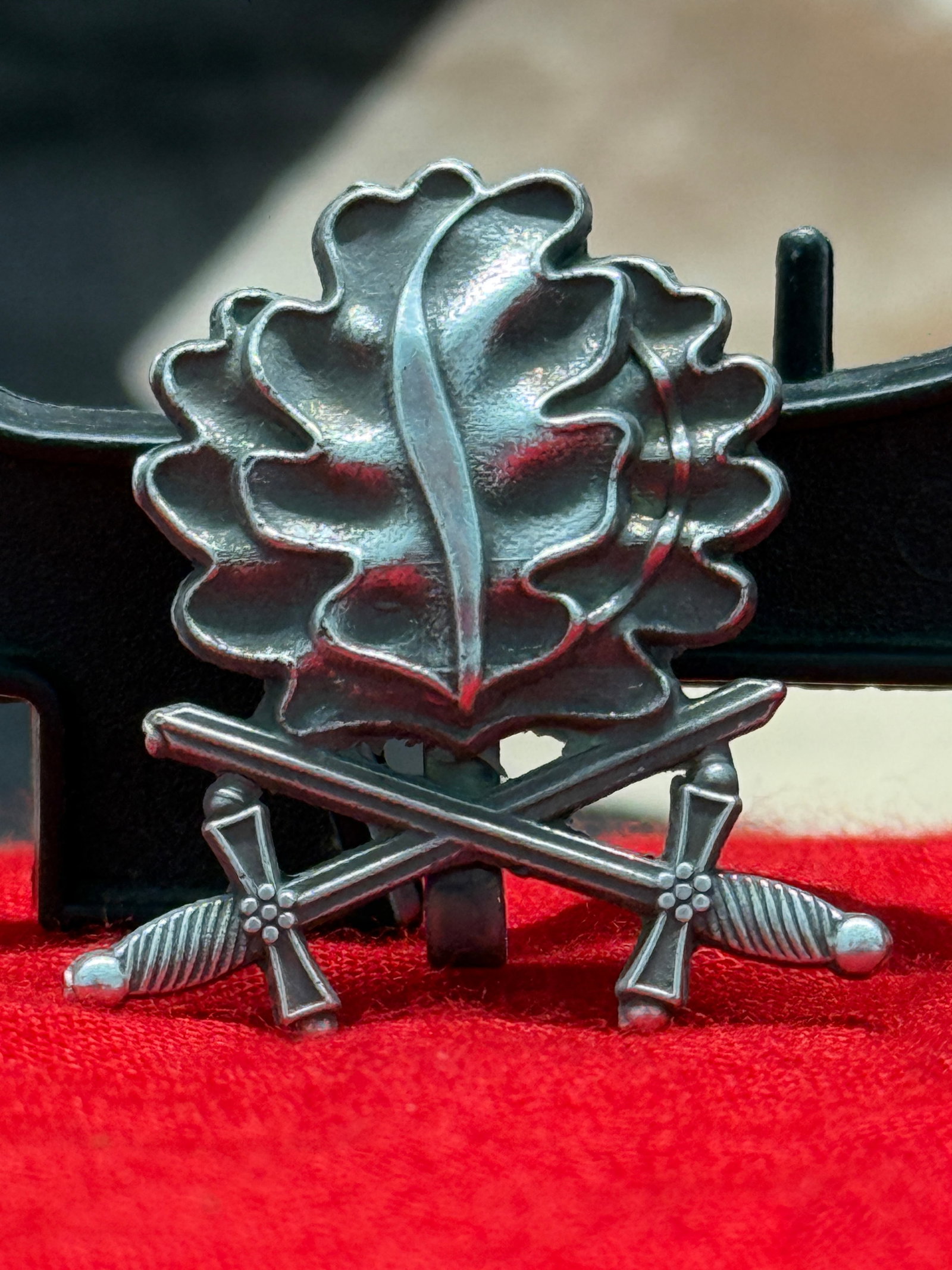 WWII German Silver Oak Leaves with Crossed Swords Lapel Badge In 900 Silver L/50: This finely crafted German lapel badge features an oak leaf cluster above crossed swords, executed in solid 900 silver and marked "900 SILBER" along with the L/50 manufacturer code on the reverse. The