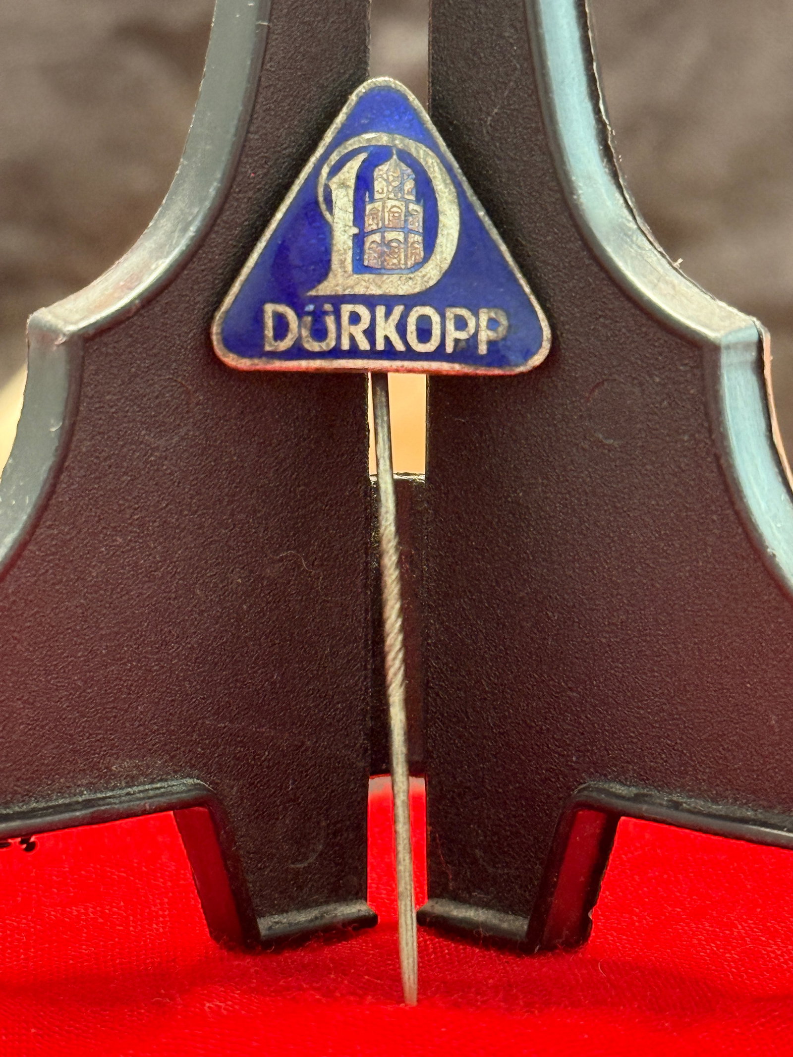 WW2 German Dürkopp Enamel Advertising Stick Pin: This triangular blue enamel stick pin bears the distinctive Dürkopp trademark and company name in gilt lettering. Dürkopp, headquartered in Bielefeld, Germany, became internationally recognized for 
