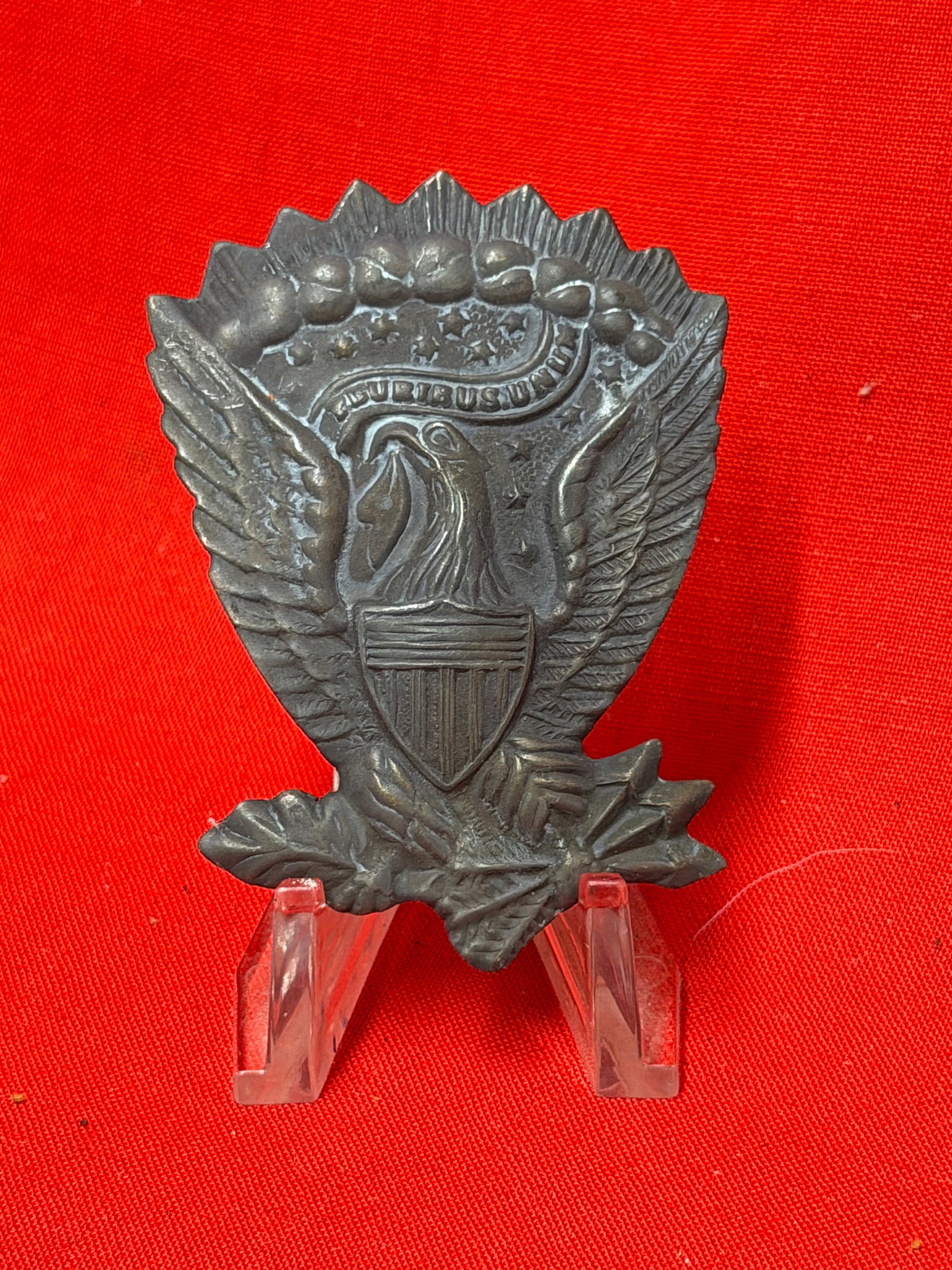 Civil War Union Federal Eagle Hat Plate Badge: This Federal eagle hat plate features the iconic spread-wing American eagle with a shield across its breast and the E Pluribus Unum motto displayed on a flowing banner above. The detailed feathering, 