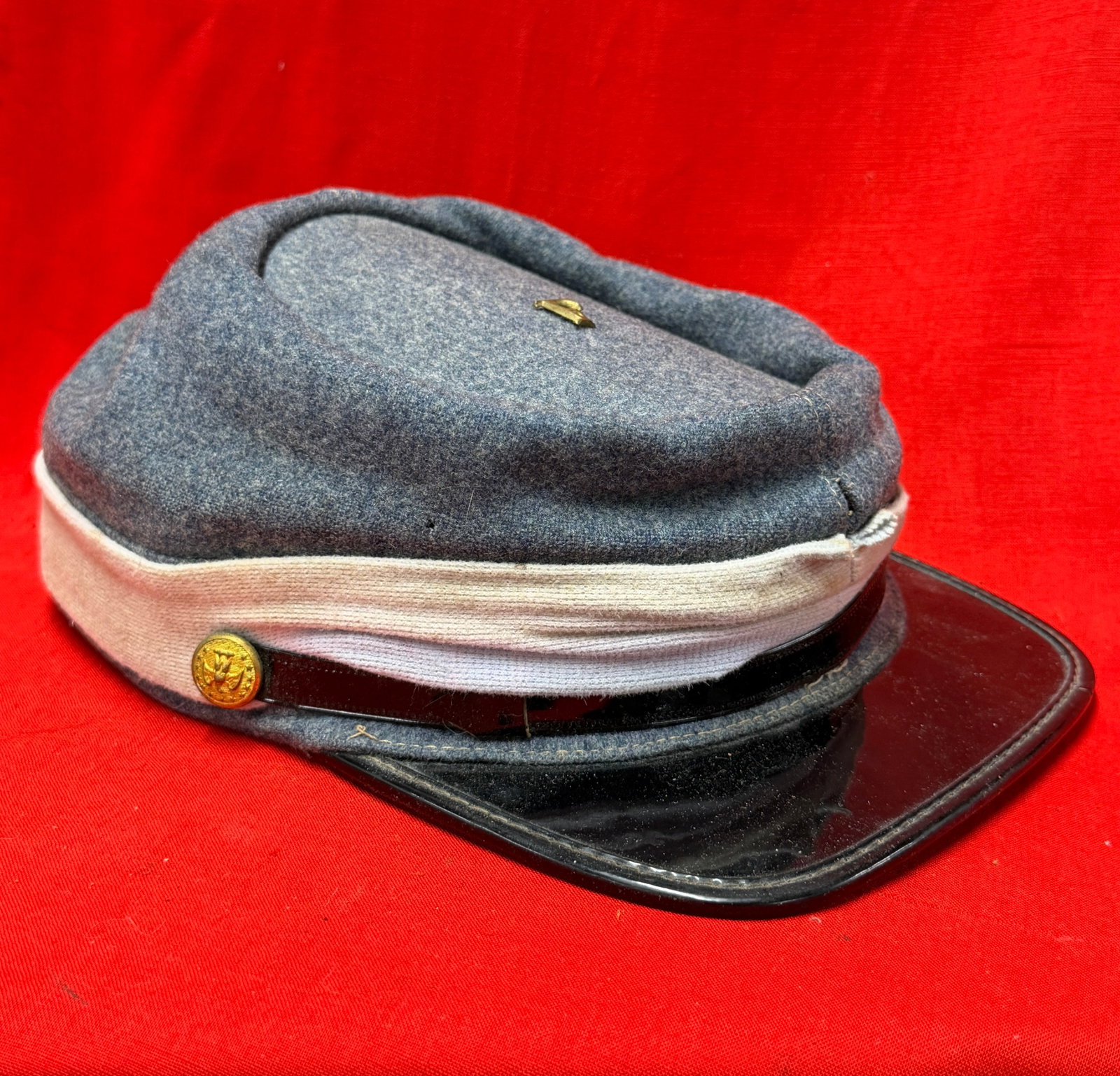 Civil War Confederate CSA Infantry Kepi Hat Cap with Confederate Eagle & 13-Star Buttons: This Civil War Confederate States Army (CSA) infantry kepi features classic gray wool construction with a white branch-of-service band, black leather visor, and brass Confederate eagle buttons display