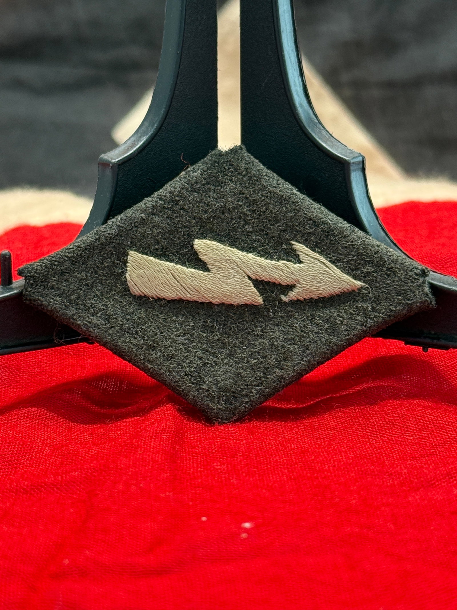 WWII German Waffen-SS Signals Collar Tab: This black wool collar tab displays the embroidered white twin lightning bolt insignia traditionally associated with the Waffen-SS Signals (Nachrichten) branch. Constructed with a black wool face and 