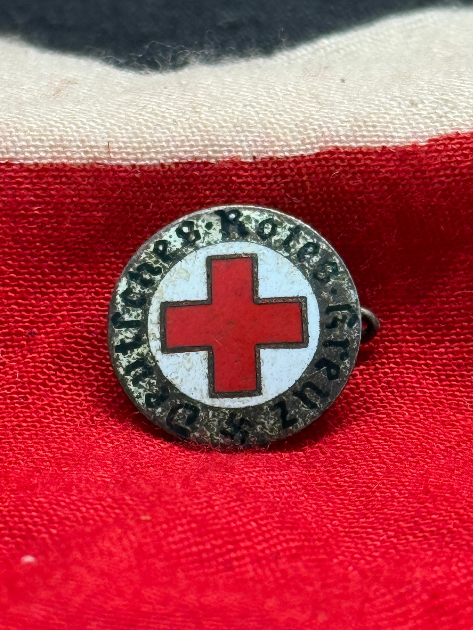 WWII German Deutsches Rotes Kreuz (DRK) Membership Lapel Pin By Ges. Gesch.: This German WWII Deutsches Rotes Kreuz (German Red Cross) membership lapel pin features the iconic red enamel cross centered within a white field and surrounded by the inscription "Deutsches Rotes Kre