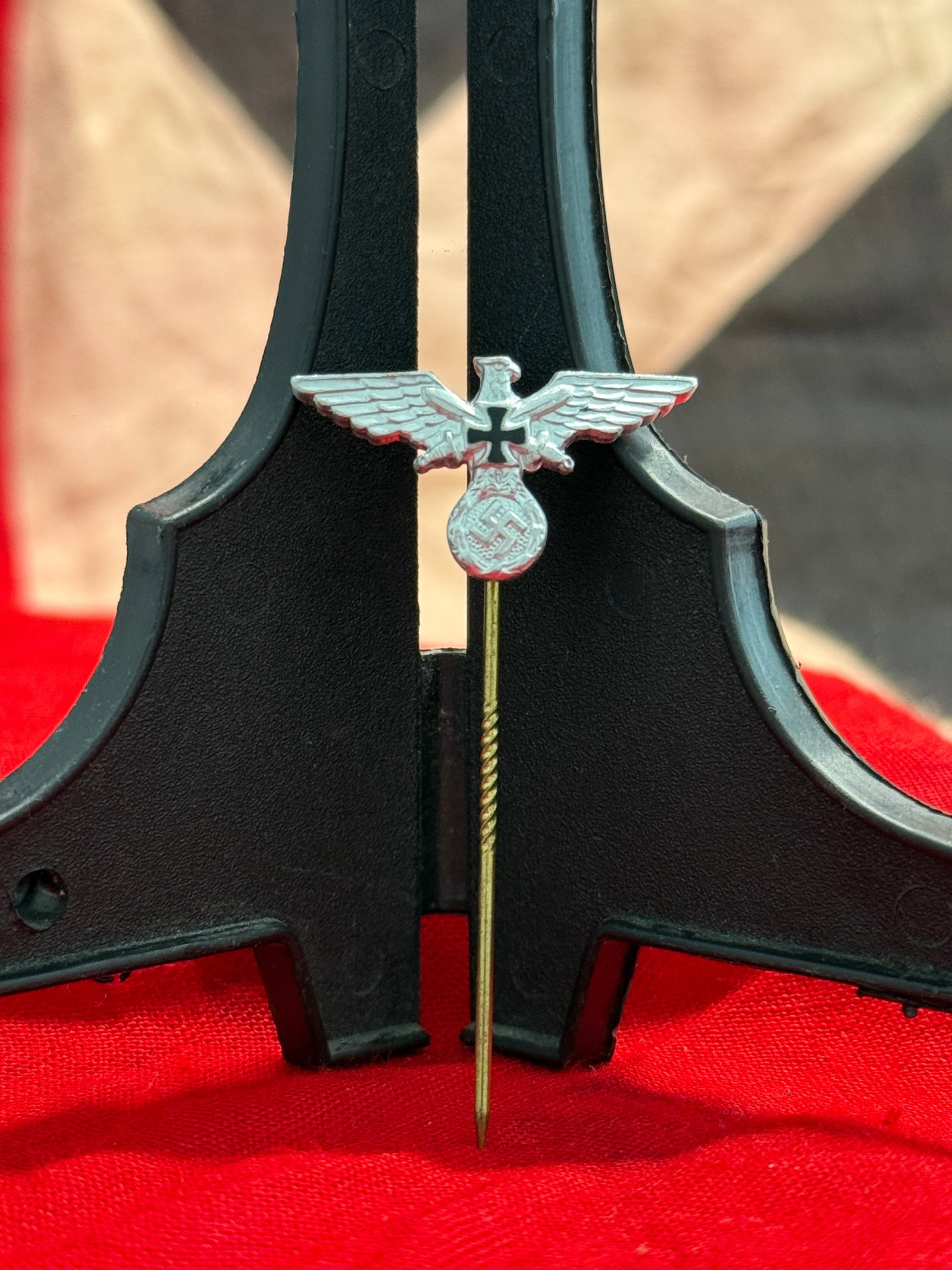 WWII German Veterans Eagle Stickpin By Ges. Gesch.: This WWII German Veterans Eagle Stickpin features a silver-toned national eagle with outstretched wings above a wreath enclosing a swastika, accented by a black Iron Cross motif across the eagle's bre