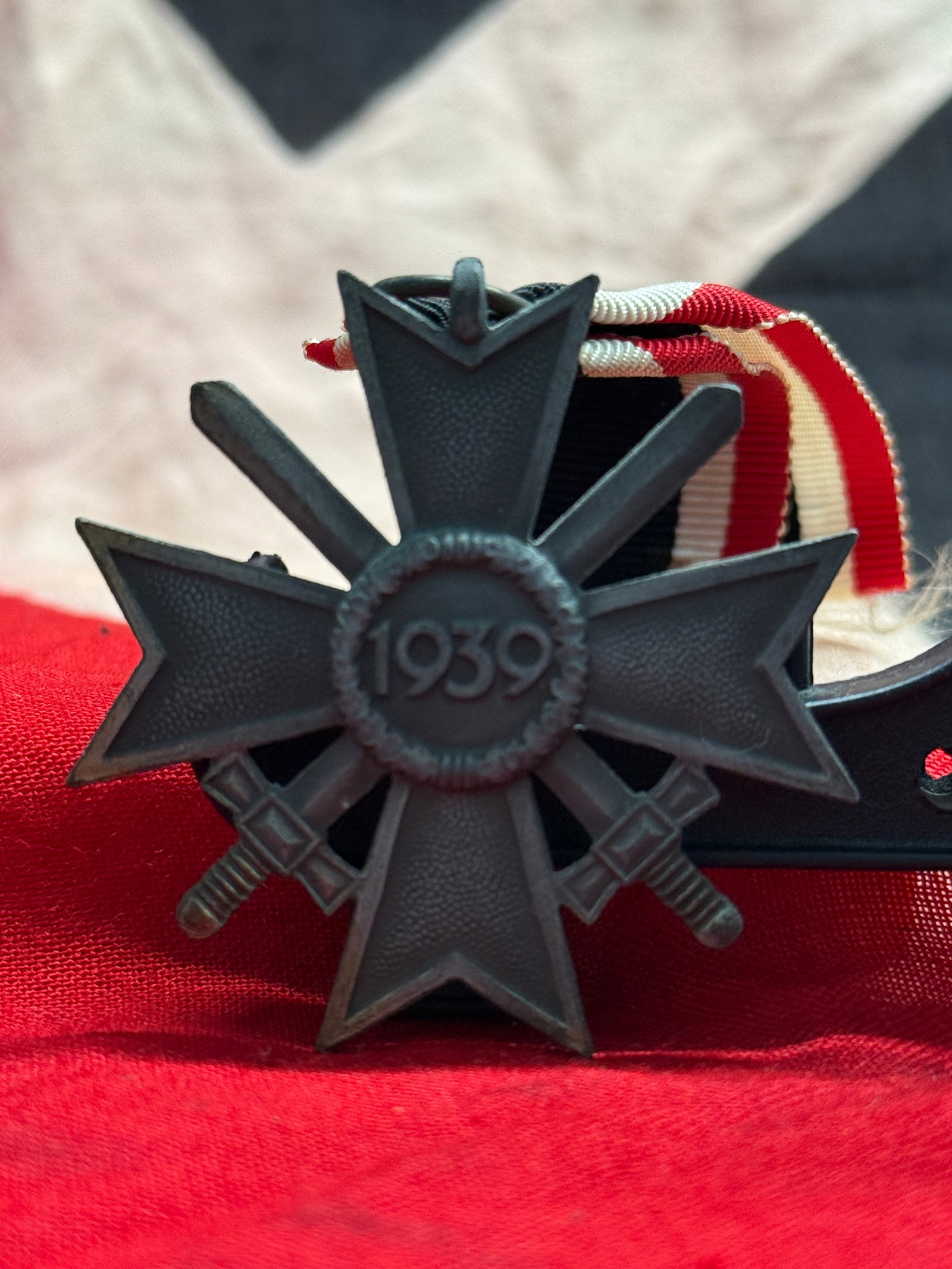 WWII German War Merit Cross 2nd Class with Swords (Kriegsverdienstkreuz 1939): Instituted in 1939, the War Merit Cross with Swords was awarded to military personnel and civilians who rendered distinguished wartime service under combat-related conditions without meeting the requi