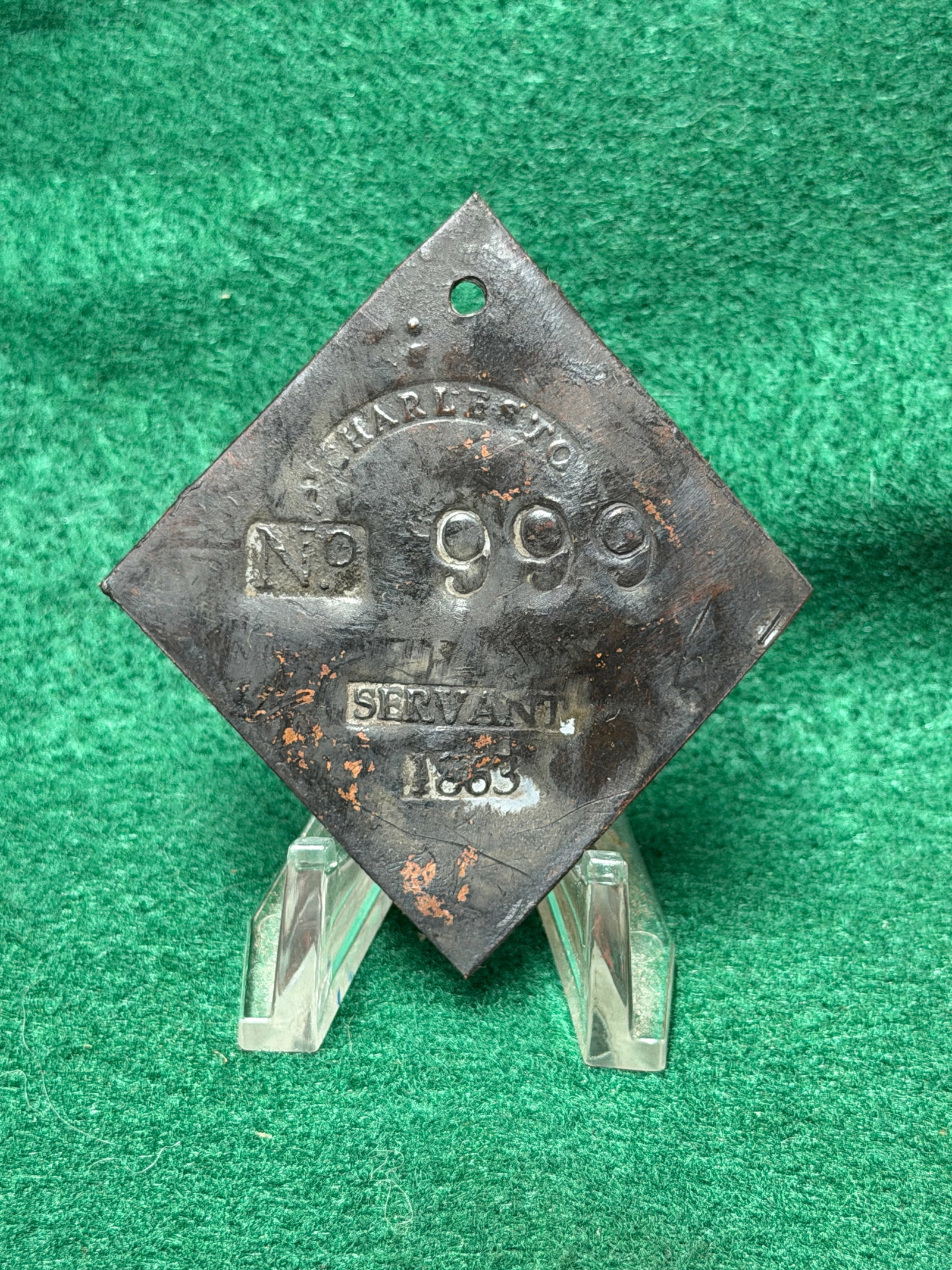 1833 Charleston No. 999 Servant Slave Tag: This 1833 Charleston No. 999 Servant Slave Tag is a diamond-shaped copper slave hire badge issued by the City of Charleston, South Carolina, bearing the stamped inscriptions "CHARLESTON," "No. 999," "