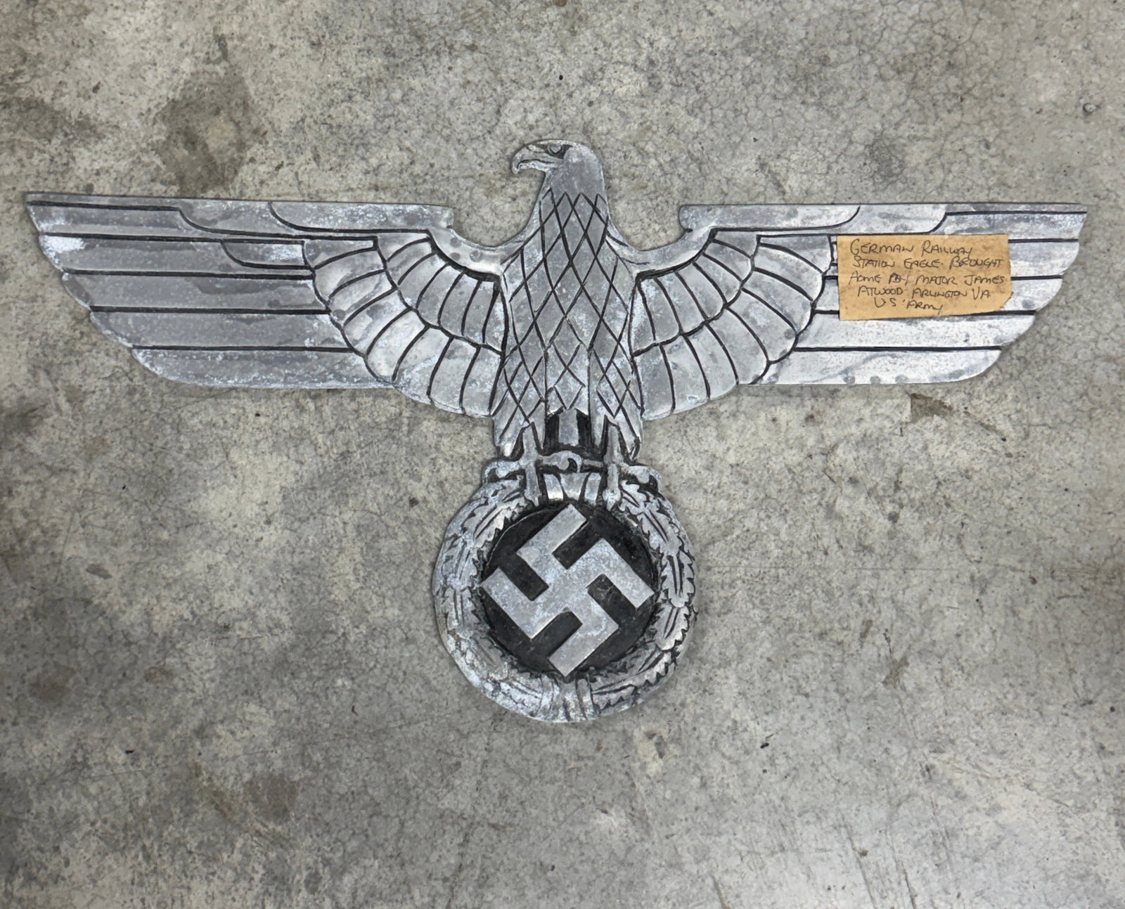 WWII German Deutsche Reichsbahn Railway Eagle Wall Plaque With Vet Bring Back Attribution: This impressive WWII German Deutsche Reichsbahn (German National Railway) eagle wall plaque features the iconic outstretched Reich eagle clutching a wreath surrounding the railway-era national emblem.