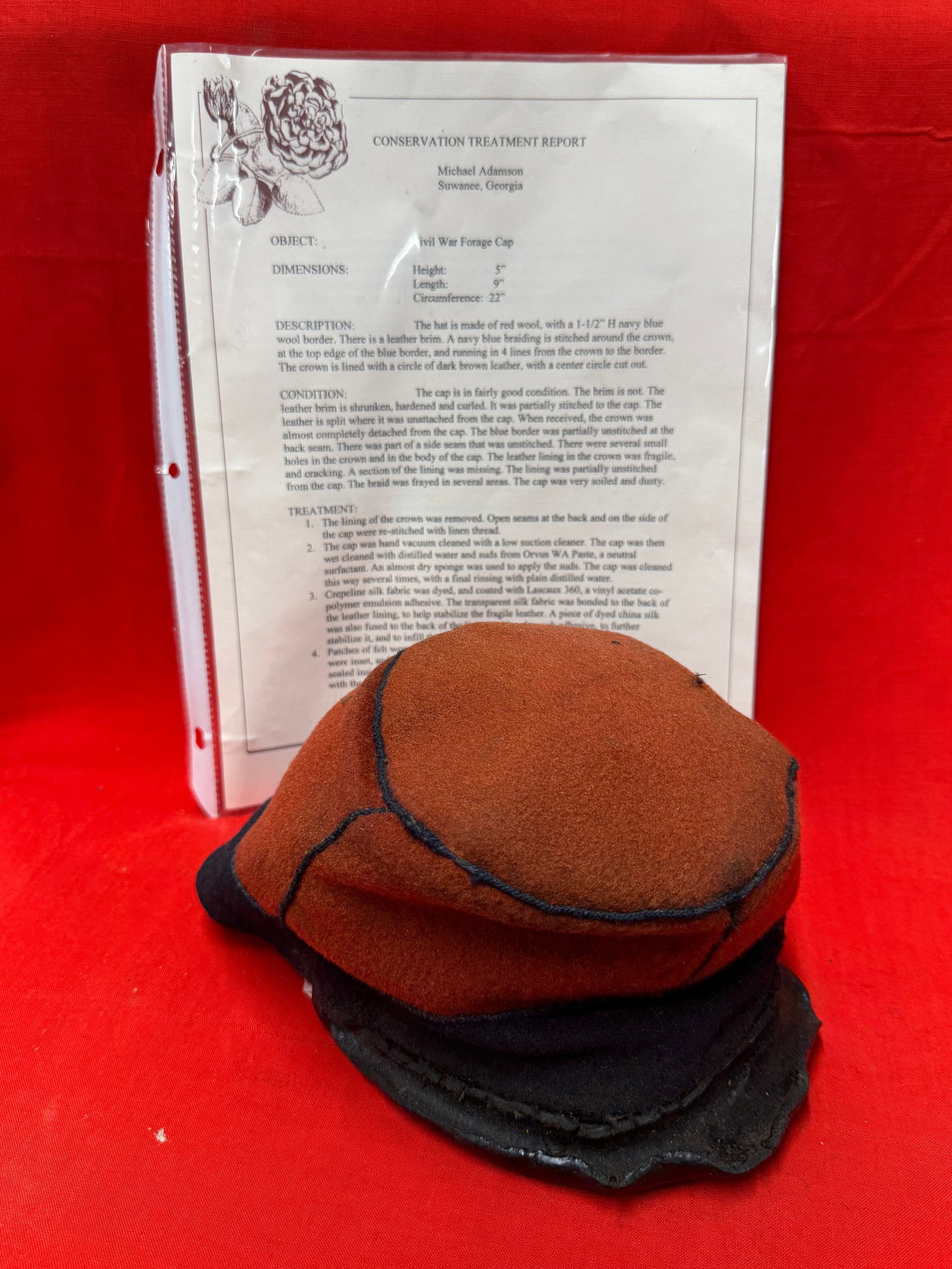 Civil War Confederate CSA Georgia Forage Cap Hat Kepi With Conservation Treatment Report: This Civil War Confederate red wool forage cap features a distinctive red wool body with dark blue wool banding and black corded trim, retaining its period form and construction. The cap is accompanie