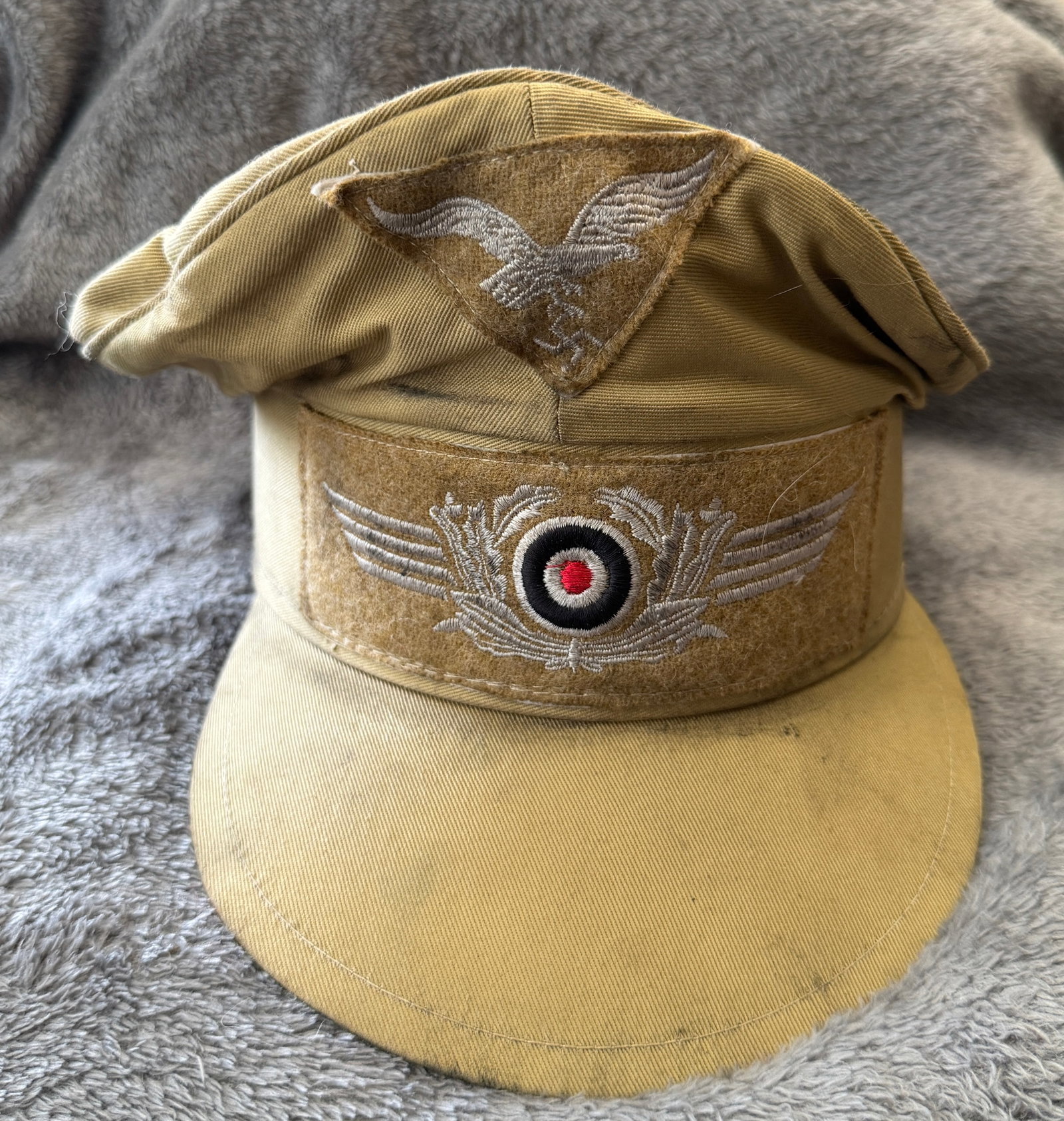 WWII German Luftwaffe Tropical Afrika Korps Field Cap: This WWII German Luftwaffe Tropical Afrika Korps Field Cap is constructed of tan tropical cotton with a short visor and features the embroidered Luftwaffe eagle on a triangular backing above the machi