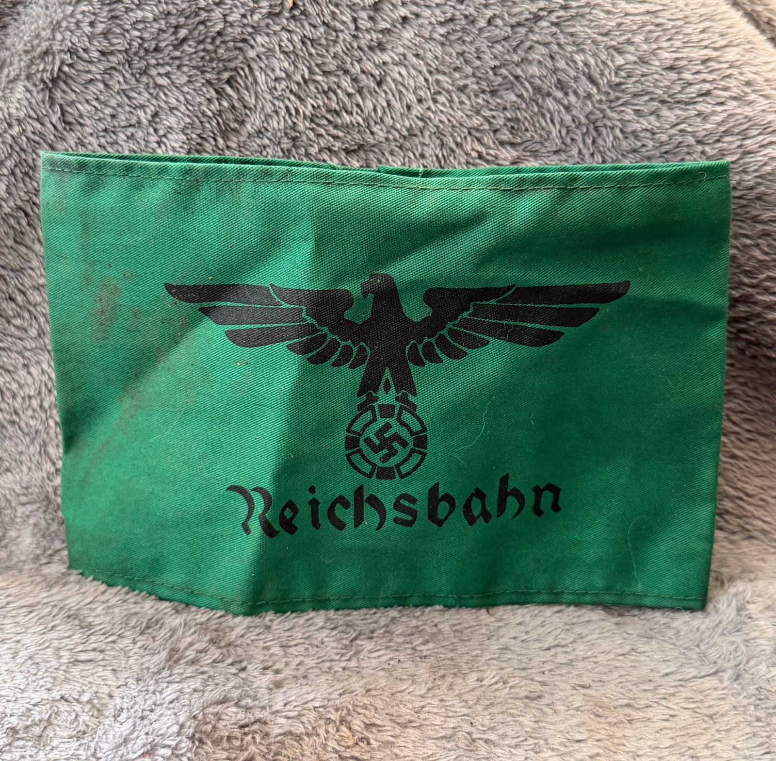 WWII German Deutsche Reichsbahn Railway Armband With RZM Paper Tag: This WWII German Deutsche Reichsbahn Railway Armband is constructed of green cotton fabric and features a black printed Deutsche Reichsbahn national eagle above the "Reichsbahn" script with the period